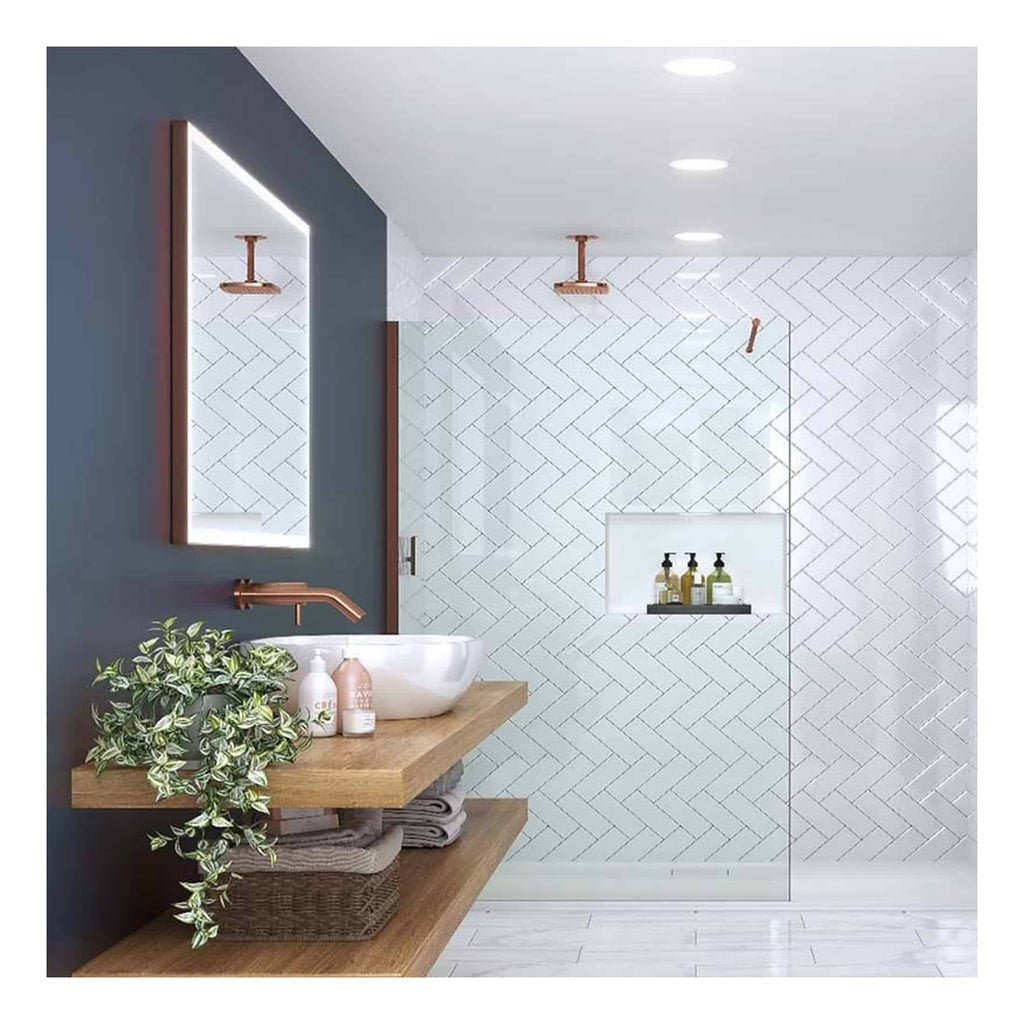Polished copper bathroom fixtures with a modern minimalist design, including a wall-mounted sink, large mirror, and sleek shower area with white herringbone tiles.