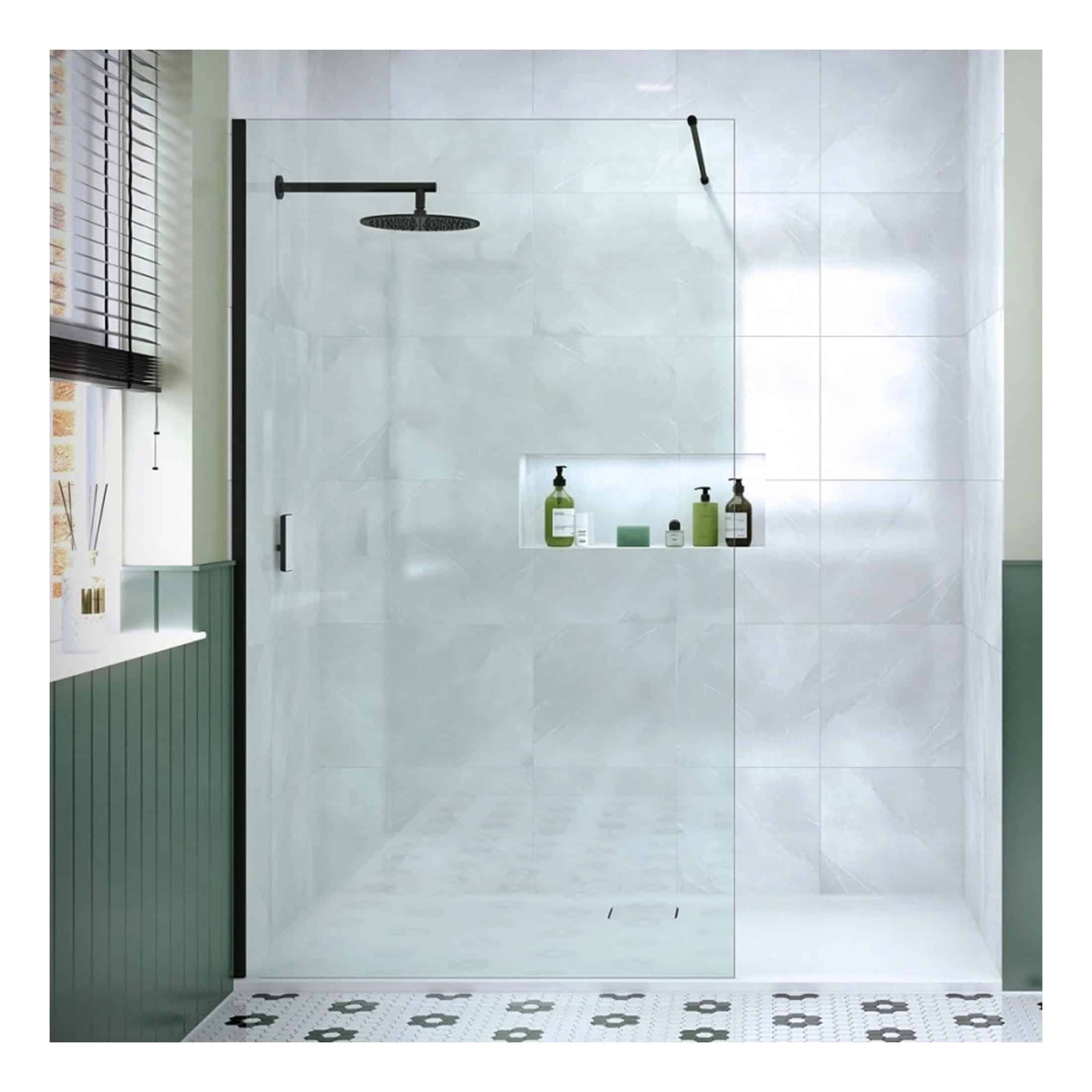 Sleek modern walk-in shower with glass enclosure, black fixtures, and minimalist design, featuring a recessed shelf for toiletries in a contemporary bathroom setting.