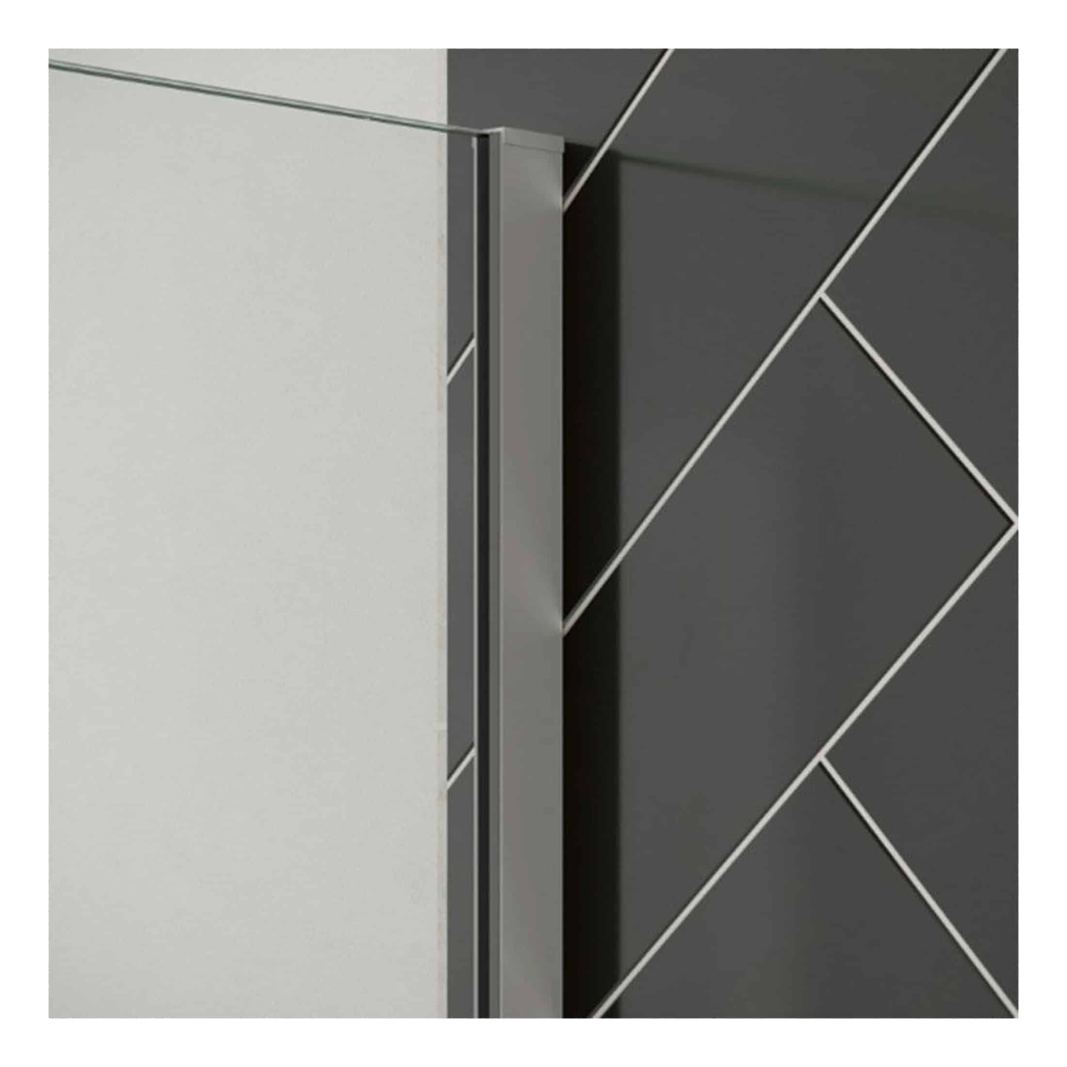 Contemporary shower partition with sleek metal frame and clear glass panels, designed for modern bathroom aesthetics by Bubly Bathrooms.