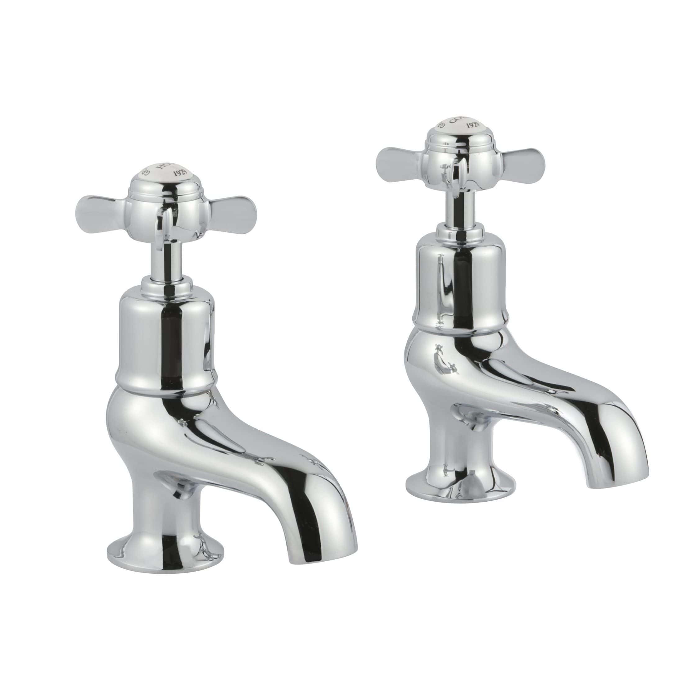 Chrome bathroom taps, traditional hot and cold water sink fixtures, high-quality bathroom plumbing accessories for classic bathroom design.