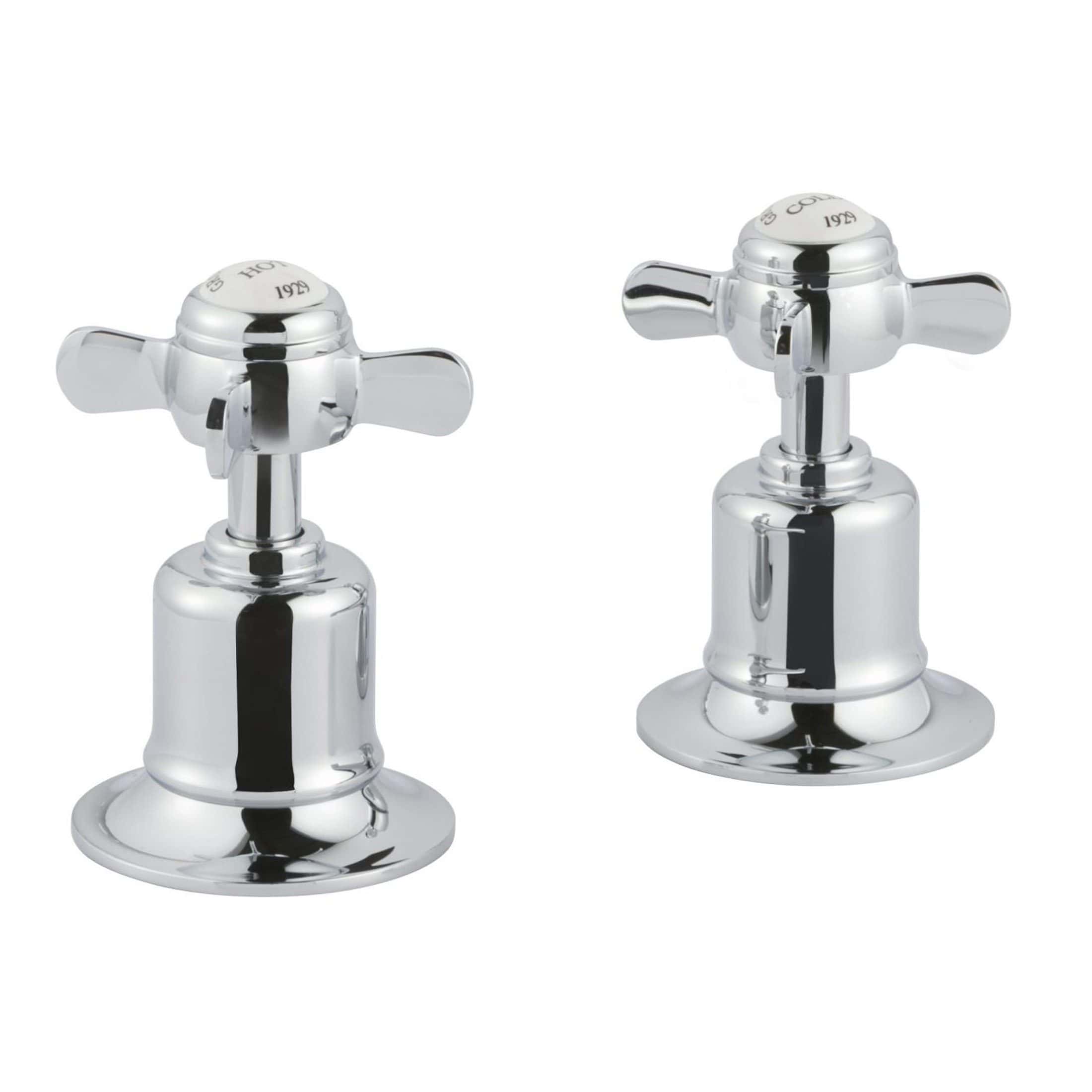 Shiny chrome bathroom taps with cross handles, designed for classic bathroom sinks, showcasing durable and elegant fixtures for contemporary and vintage bathroom remodels.
