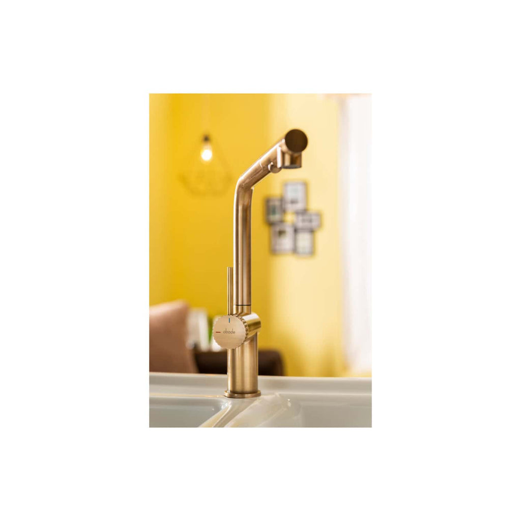 Sleek modern kitchen sink faucet in brushed gold finish with a contemporary design, set against a vibrant yellow kitchen wall, showcasing premium bathroom and kitchen fixtures.