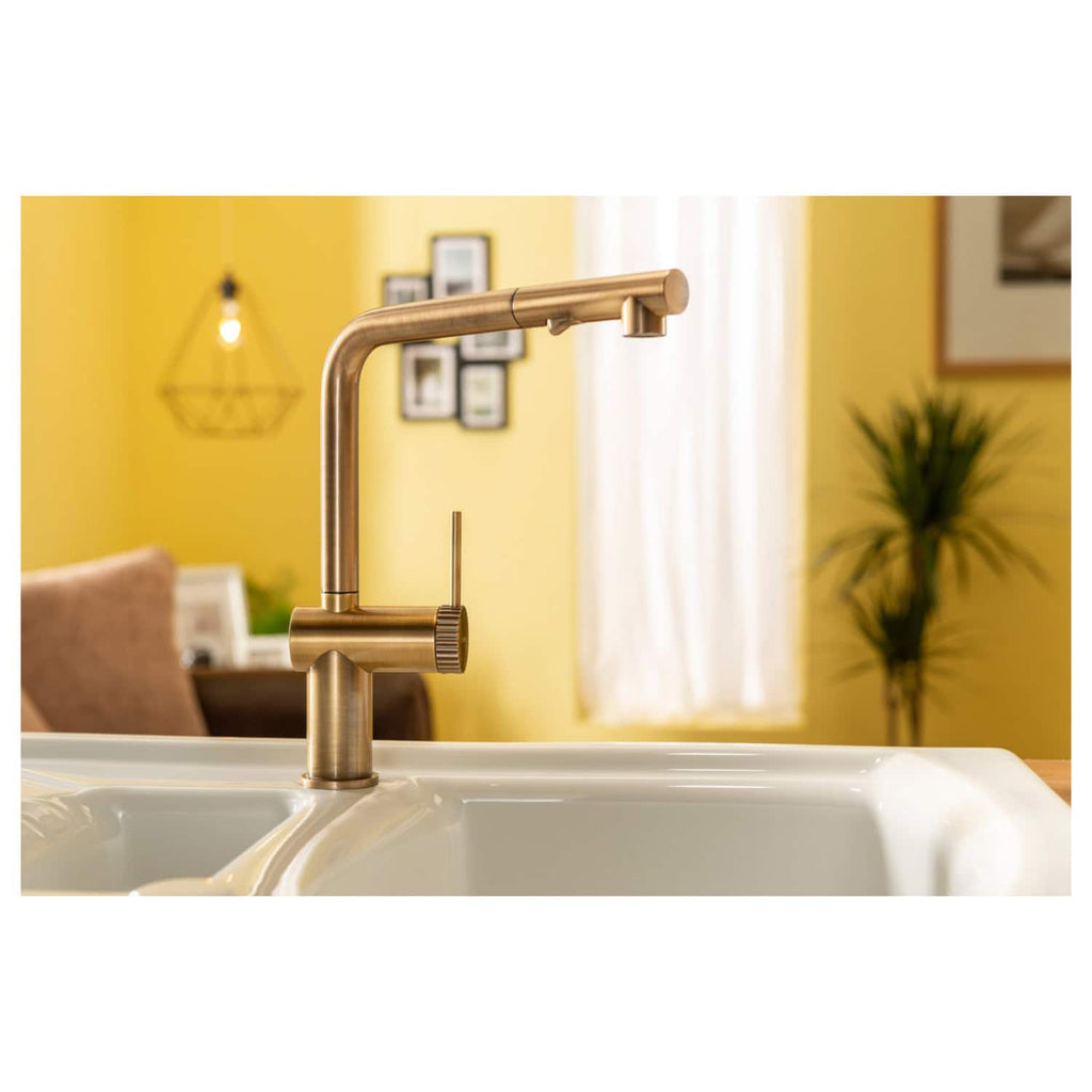 Brass kitchen sink tap in a modern kitchen with yellow walls, white sink, and natural light. Stylish and functional kitchen fixture perfect for contemporary kitchen designs.