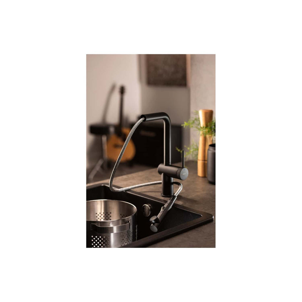 Sleek black kitchen tap with pull-out spray in modern kitchen setting, close-up view showcasing stylish design and functionality.