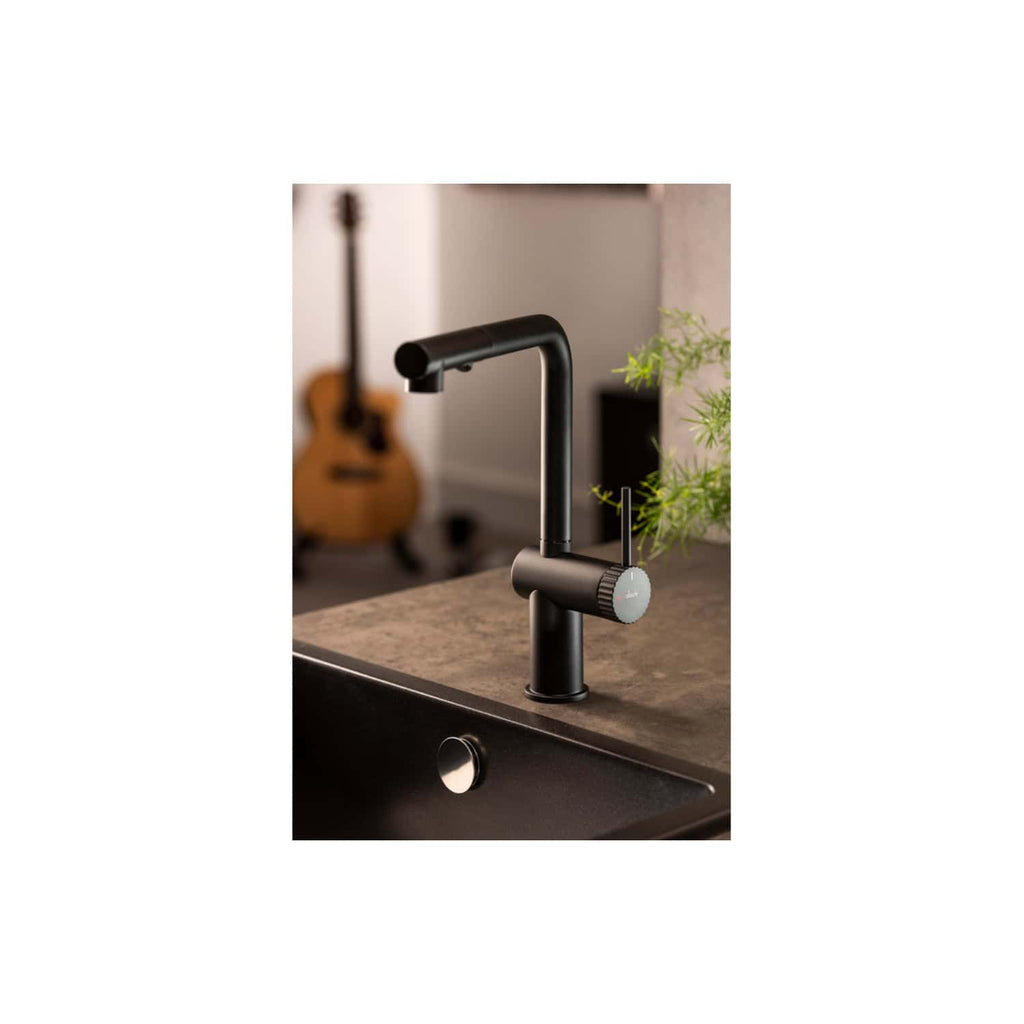 High-quality black kitchen tap with modern design, featuring a pull-out spray head, installed on a dark stone countertop with greenery in the background, perfect for contemporary bathrooms.