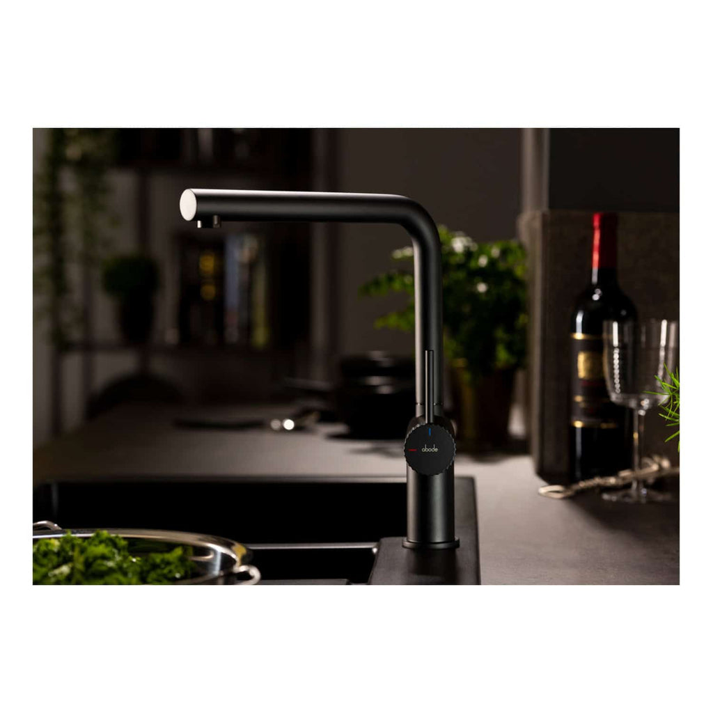 Futuristic black kitchen tap with touch control, modern design, and sleek finish, installed on a kitchen countertop surrounded by wine bottles, glasses, and plants, ideal for luxury bathroom or kitchen remodels.