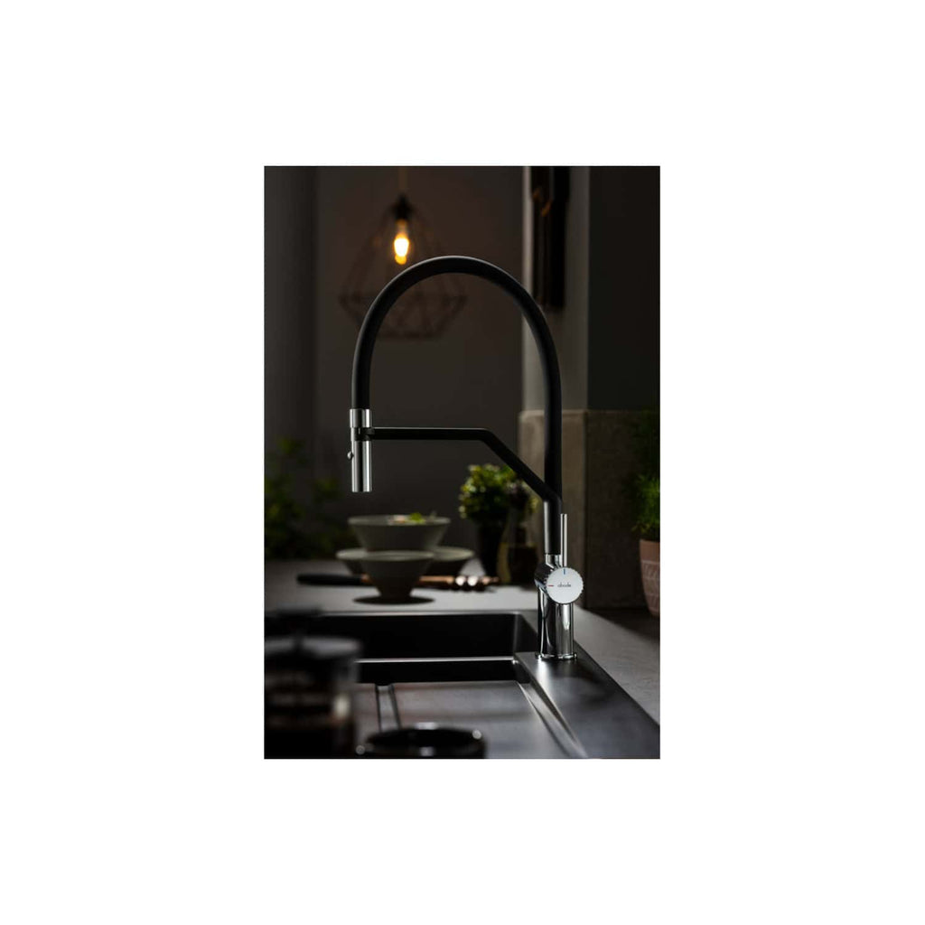Sleek modern black kitchen tap with chrome accents, installed over a stainless steel sink, in a contemporary kitchen setting.