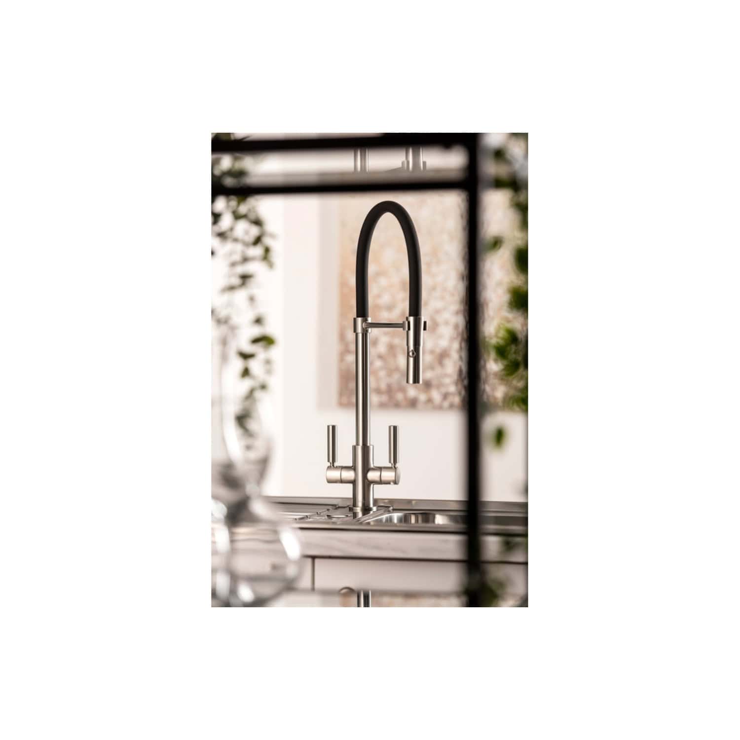 Sleek modern kitchen sink with a stainless steel tap featuring a flexible black hose and minimalist design, ideal for stylish bathroom or kitchen renovations.