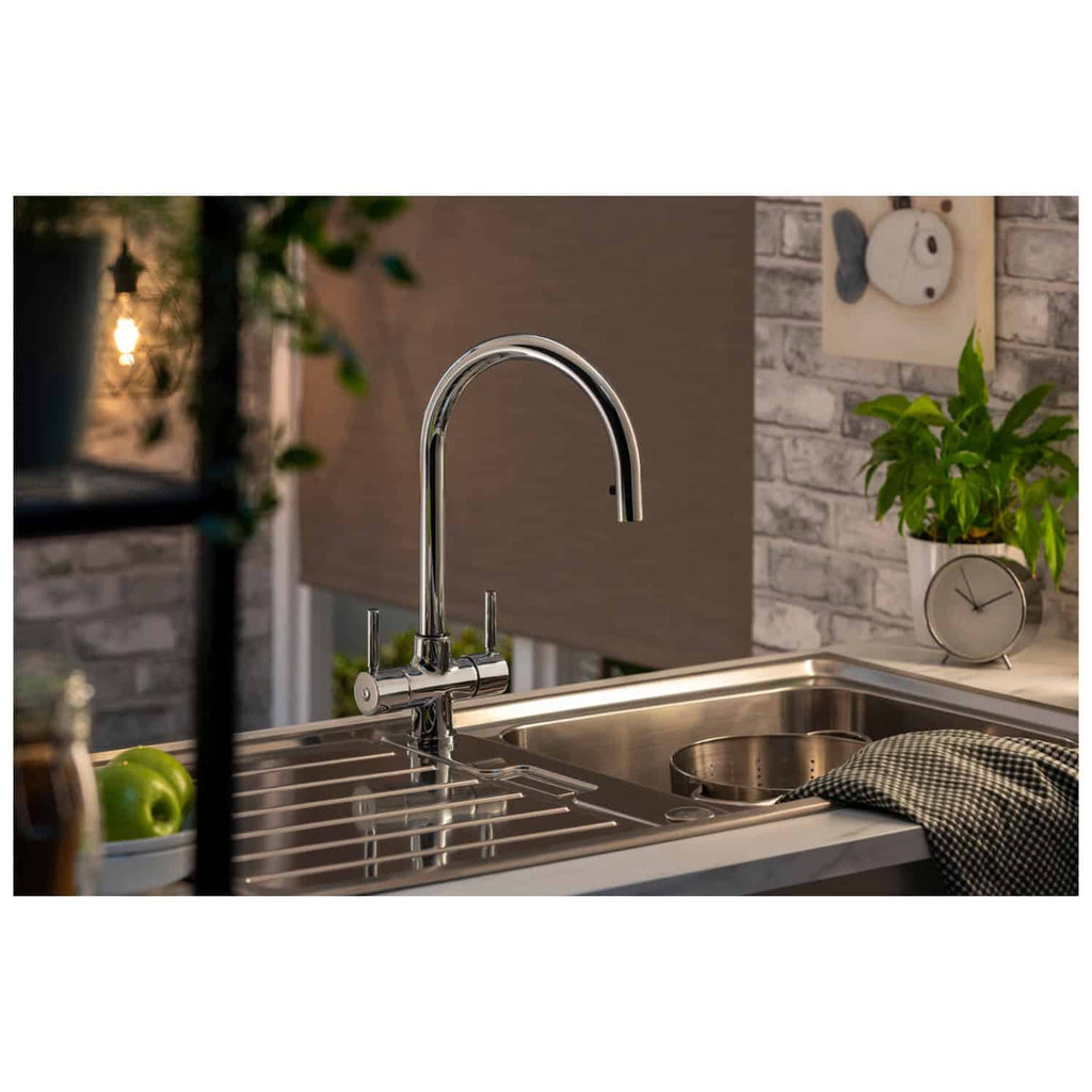 Polished chrome kitchen tap with high-arc design in a modern kitchen setting.