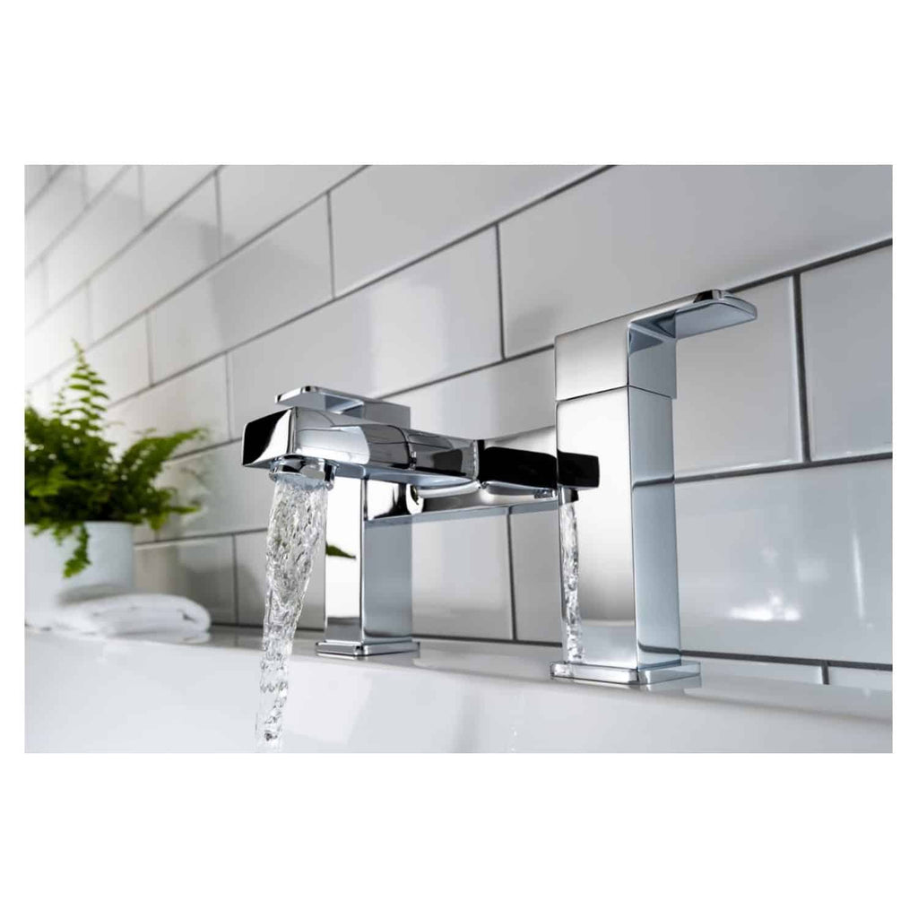 Shiny chrome bathroom tap with flowing water mounted on white tiled wall, modern bathroom accessories, elegant design for contemporary bathrooms.