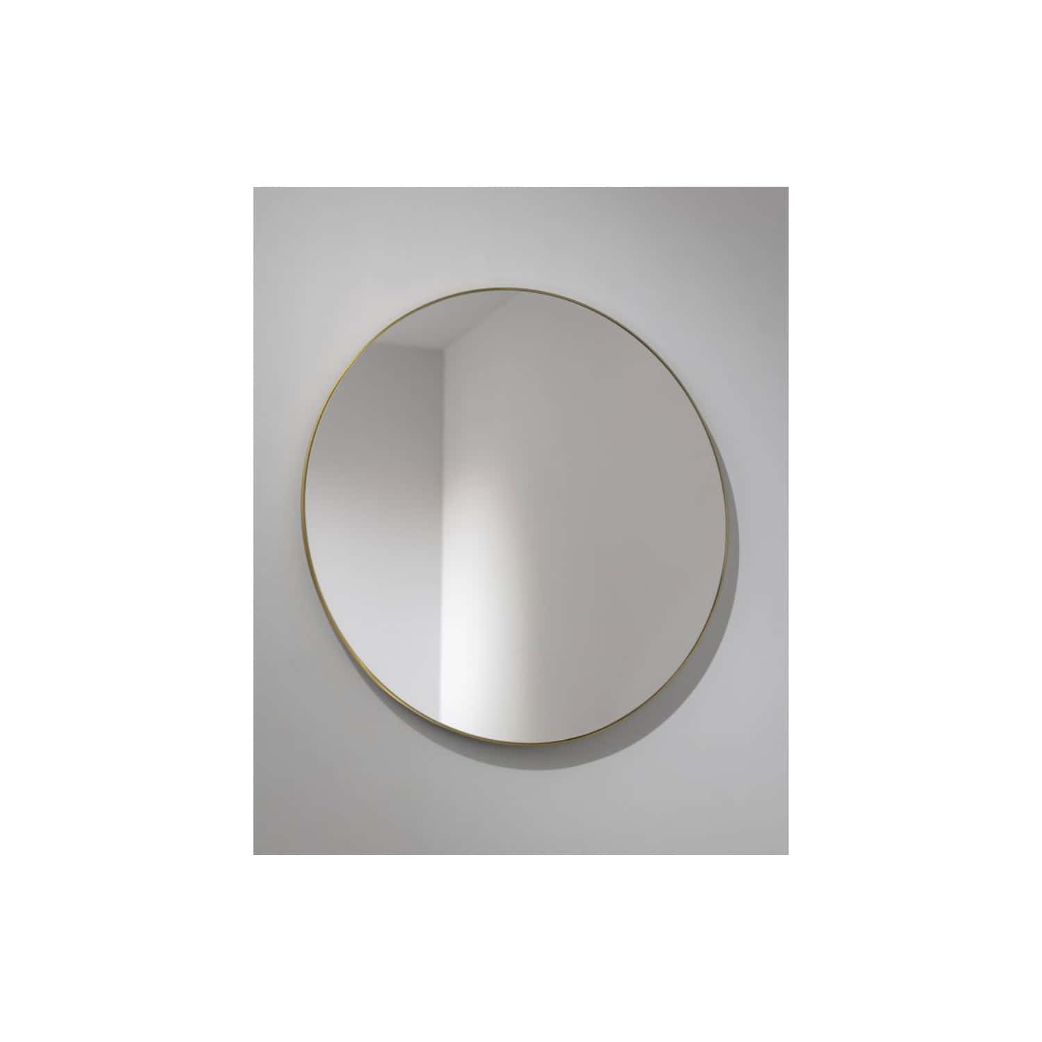 A round wall mirror with a thin gold frame mounted on a white wall, ideal for modern bathroom decor and enhancing space and light.