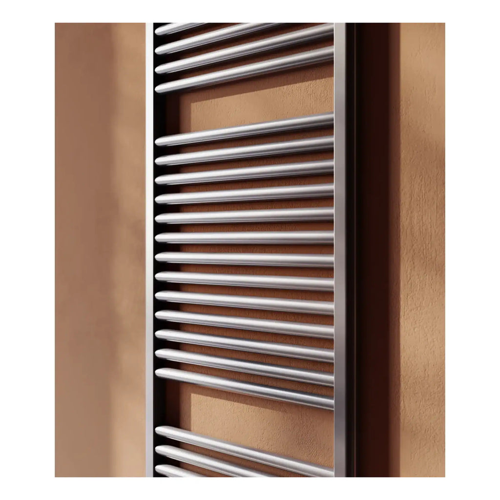 Polished stainless steel towel radiator in modern bathroom decor, ideal for heating and drying towels with a sleek, stylish design.
