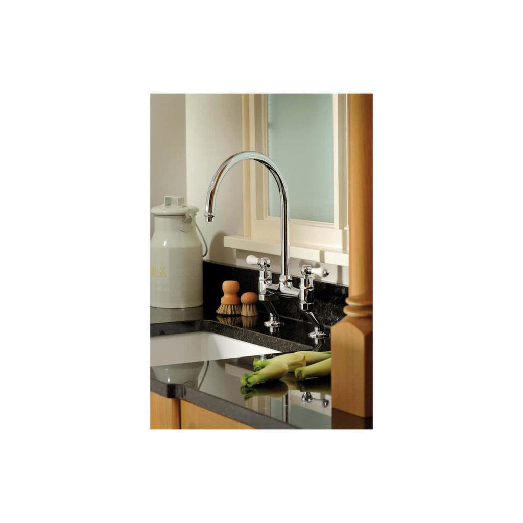 Shiny kitchen sink with chrome faucet in modern kitchen, featuring black countertop, wooden cabinets, and fresh vegetables, highlighting stylish bathroom or kitchen fixtures.