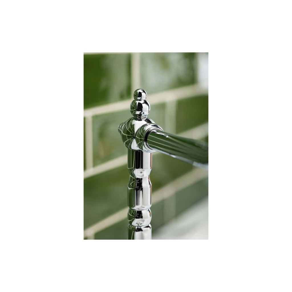 Shiny chrome bathroom tap with green tiled wall background, modern fixtures, close-up, high-quality plumbing hardware, luxurious bathroom design, Bubly Bathrooms.