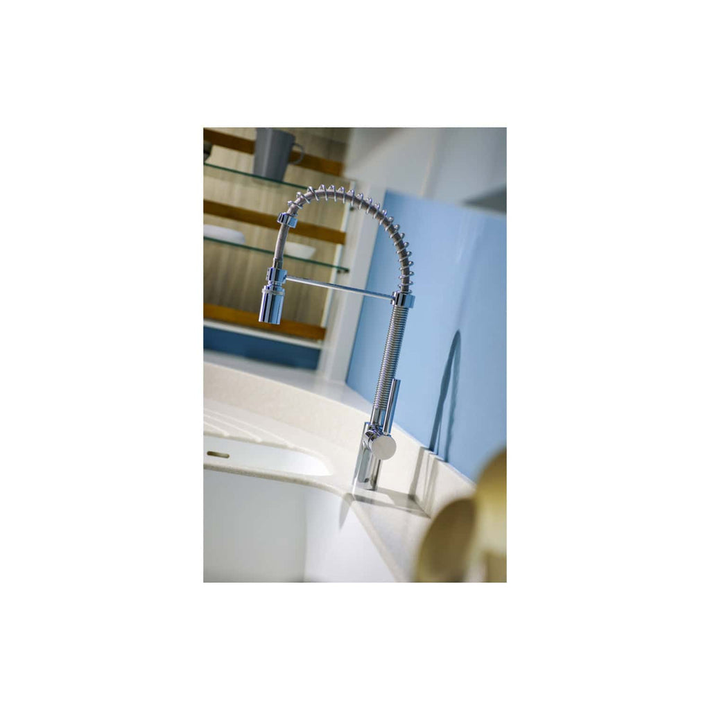 Flexible chrome kitchen mixer tap with pull-out spray head, modern design, installed in a contemporary kitchen sink. Ideal for Bubbly Bathrooms' stylish bathroom and kitchen fixtures.