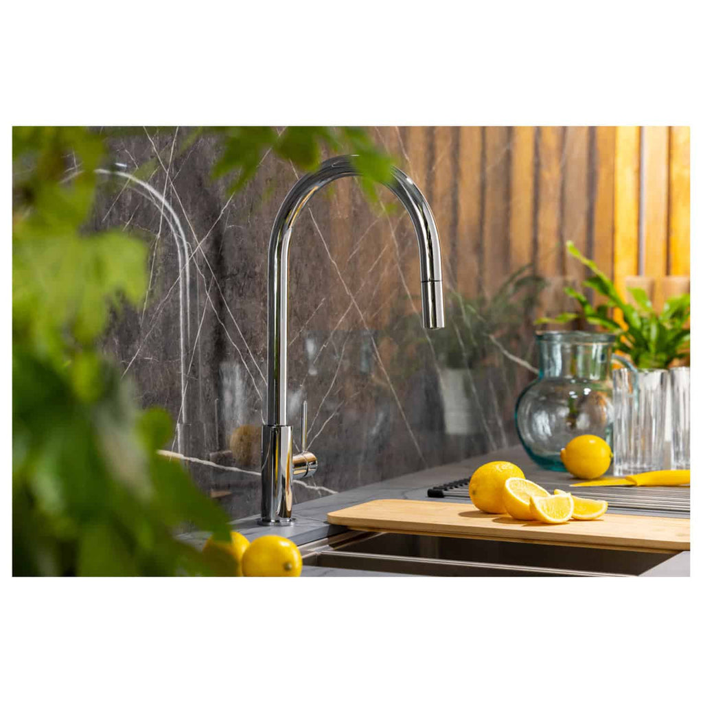 Shiny chrome kitchen tap with a marble backsplash, surrounded by fresh lemons and greenery, showcasing modern kitchen design and the premium quality of Bubly Bathrooms fixtures.