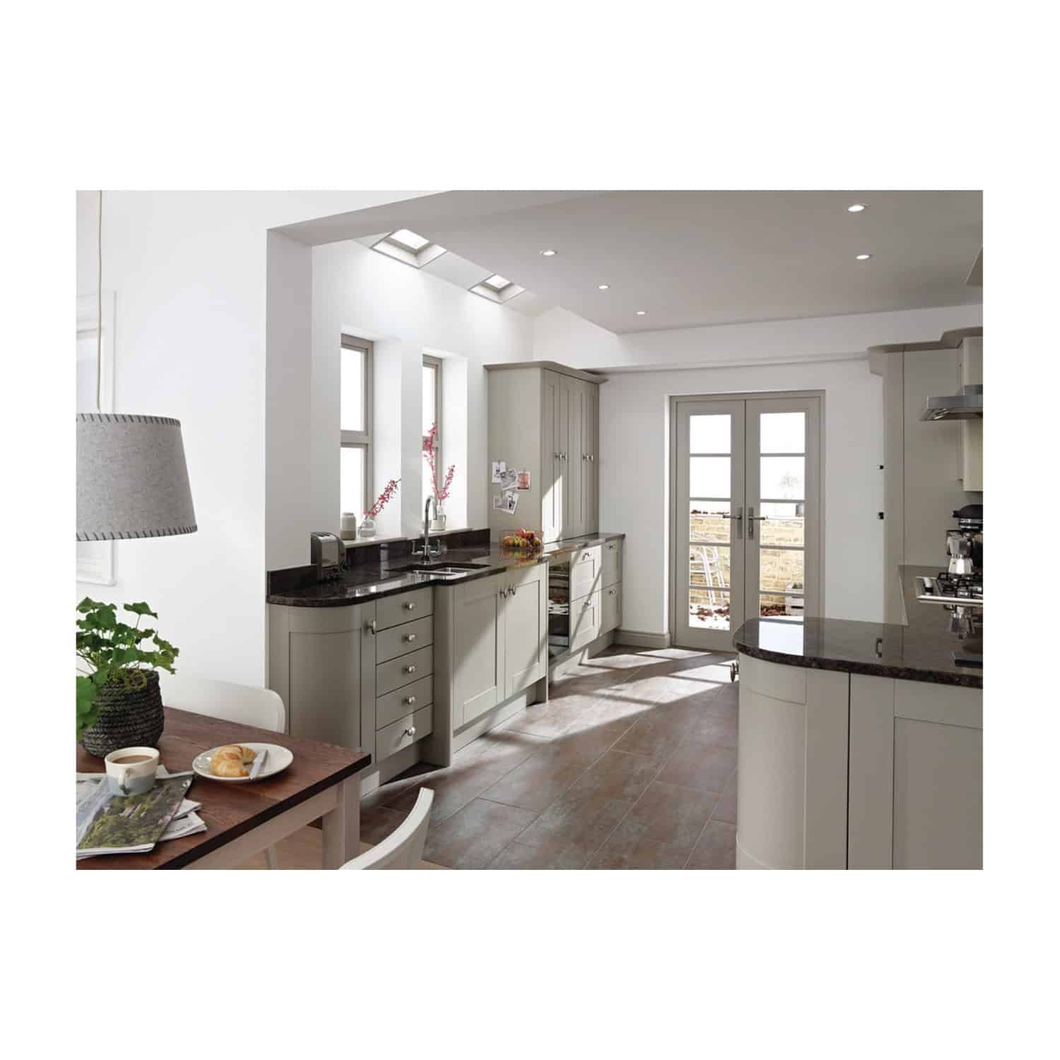 Modern kitchen with white cabinets and black granite countertops, bright natural light from skylights and windows, sleek and contemporary design, perfect for stylish home living.