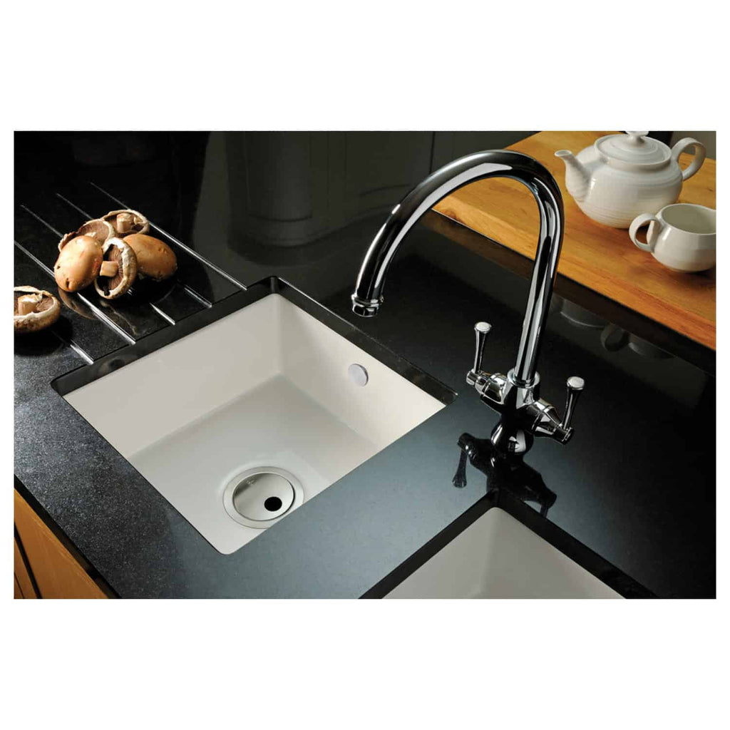 Sleek black kitchen countertop with dual white sinks, chrome faucet, and wooden accents, ideal for modern kitchen design and premium kitchen fixtures.