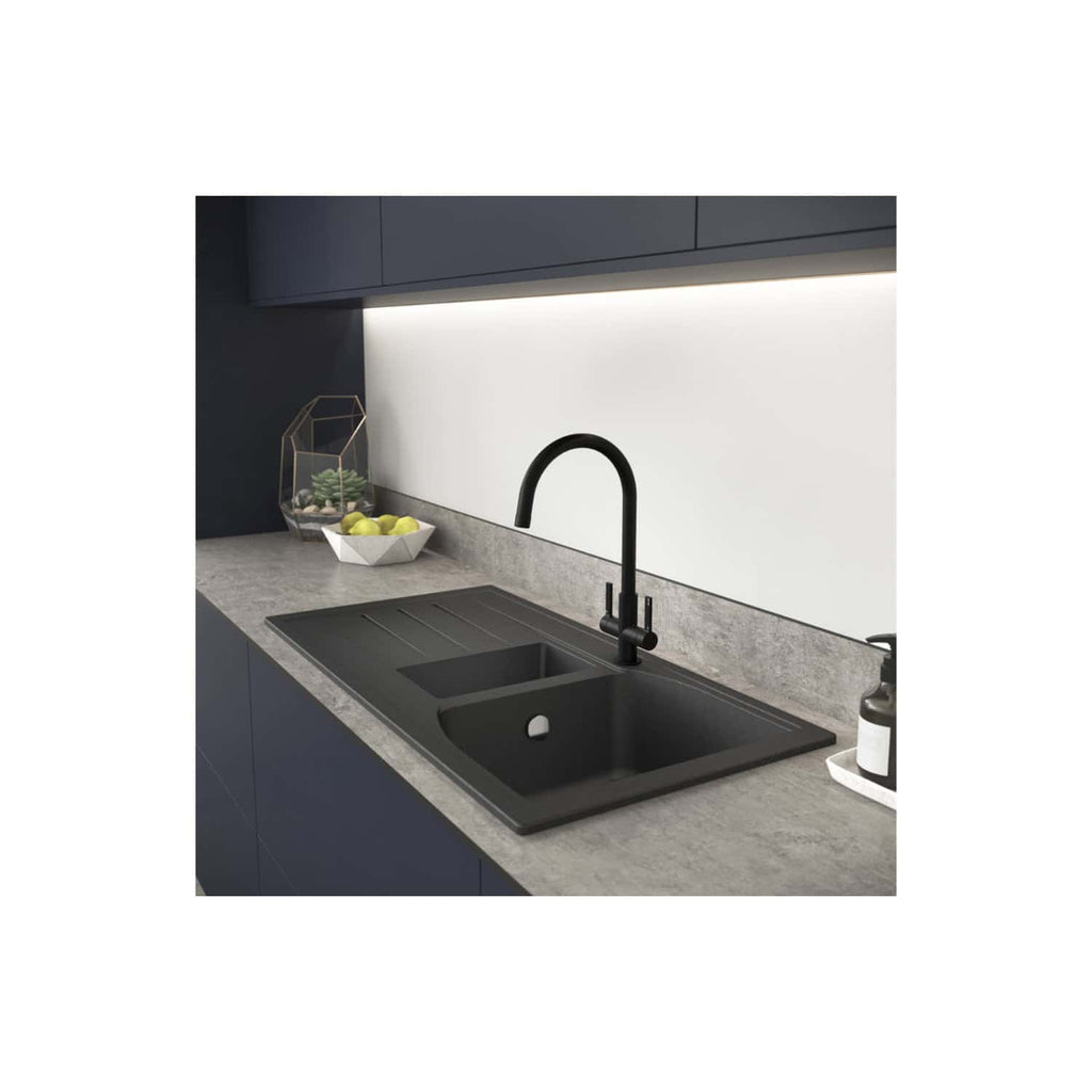 Sleek black kitchen sink with matching matte black faucet in modern minimalist kitchen, grey marble countertop, under-cabinet lighting, and contemporary decor elements.