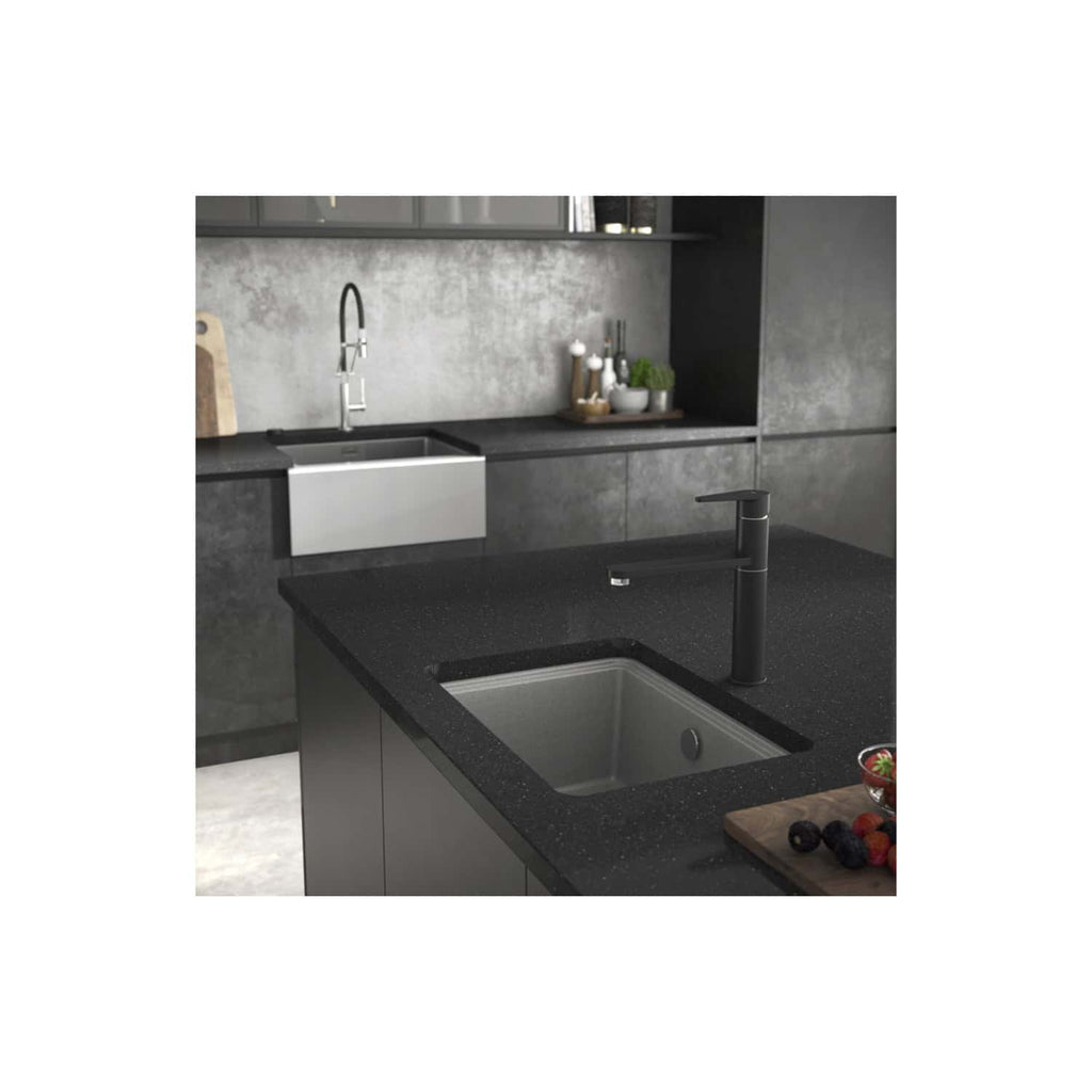 Sleek black kitchen countertop with built-in stainless steel sink and modern matte black faucet, set in a contemporary kitchen with dark grey cabinetry and stylish kitchen accessories for a sophisticated look.