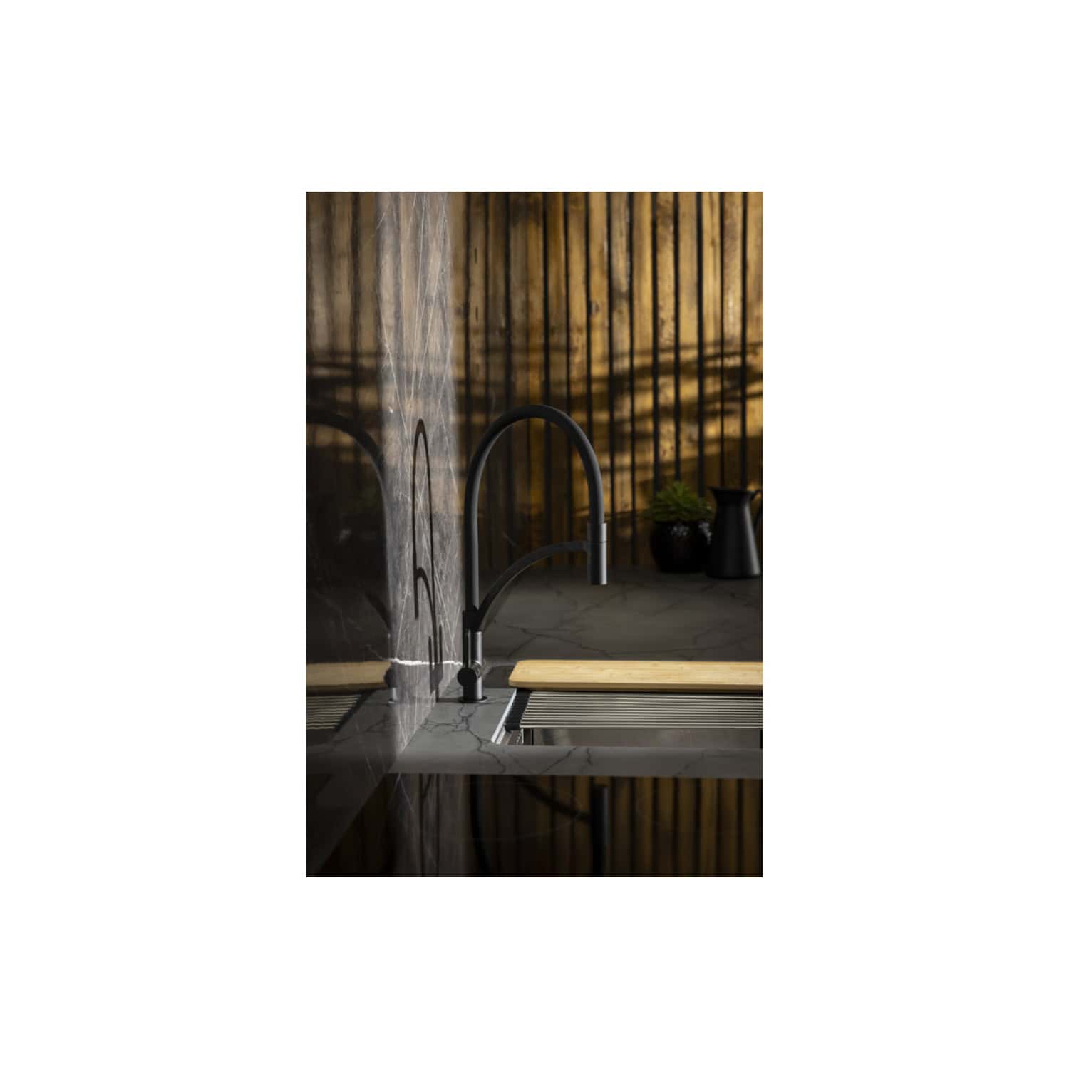 Sleek black kitchen faucet with modern design, mounted on a marble countertop with a wooden cutting board, in a contemporary kitchen with wooden wall paneling and decorative vases.