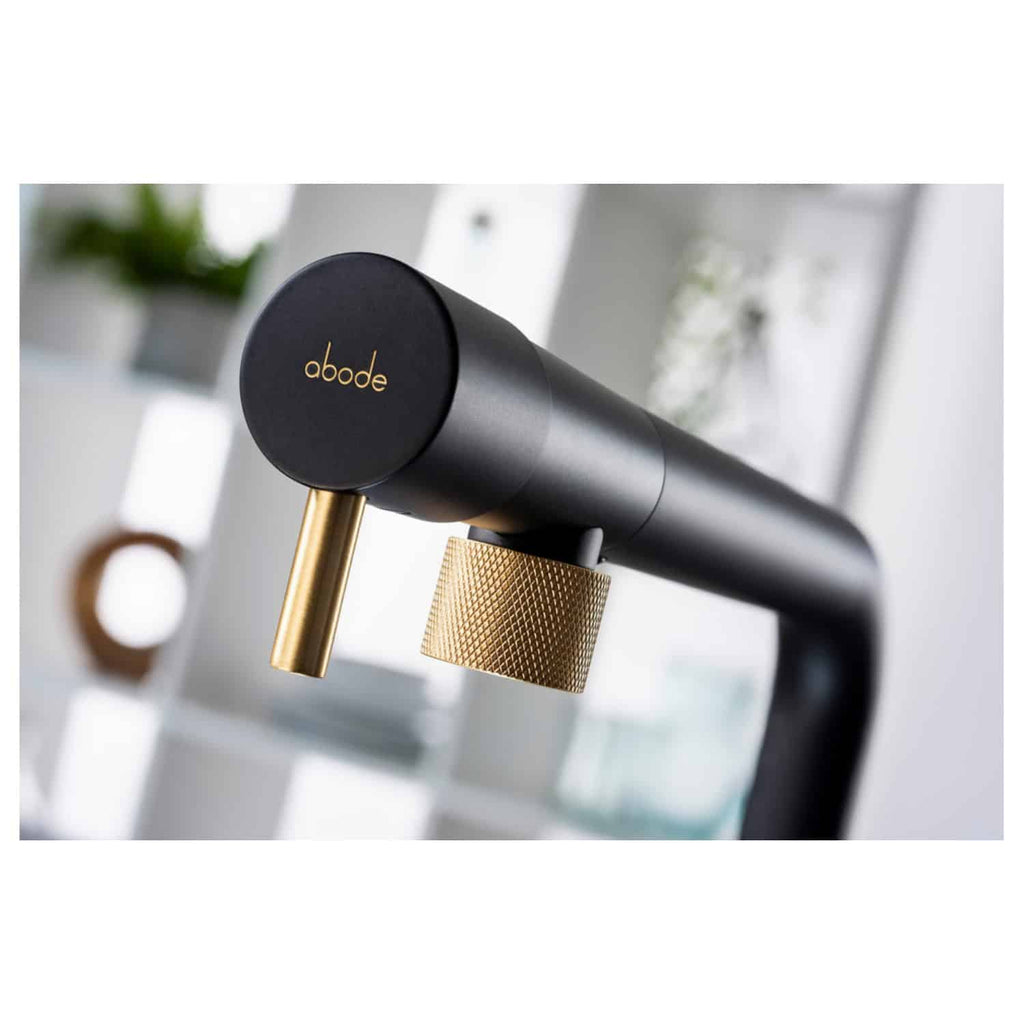 Brass-finished modern bathroom tap with black and gold accents, sleek design for luxury bathroom fixtures, high-quality fixtures from bubly.co.uk involving premium tapware for elegant bathroom setups.