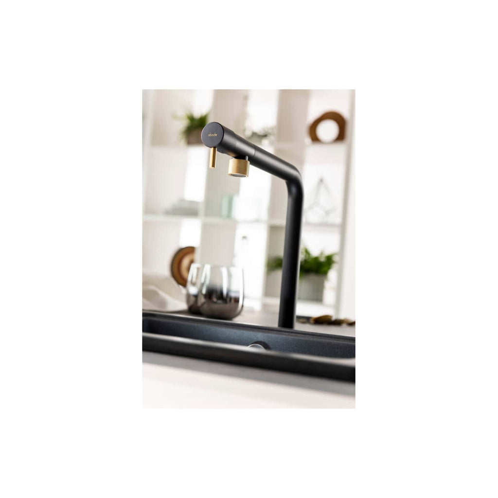 Sleek black kitchen tap with gold accents in modern bathroom setting, featuring a minimalist and contemporary design for stylish and functional kitchen faucets.