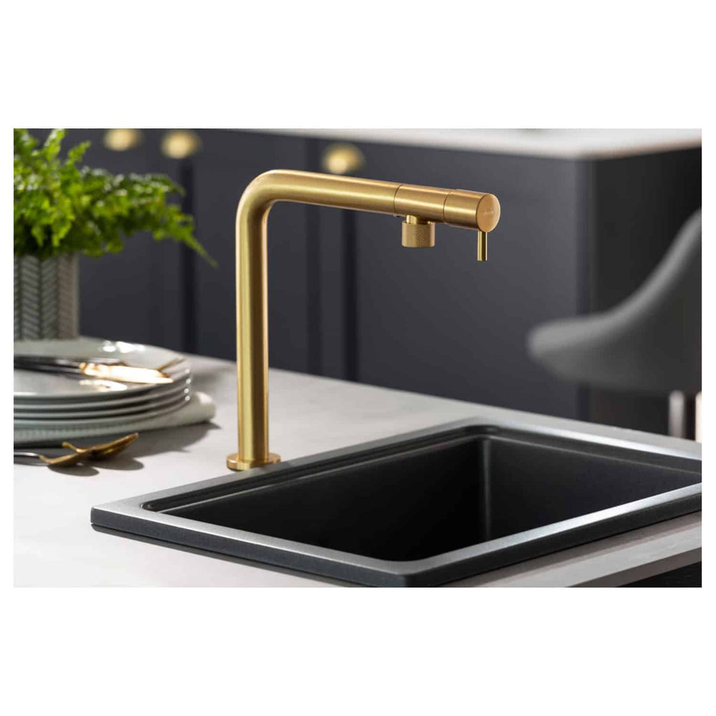 Sleek black kitchen sink with elegant gold faucet in modern Bubly Bathrooms showroom, showcasing luxurious and stylish kitchen fixtures for contemporary home design.