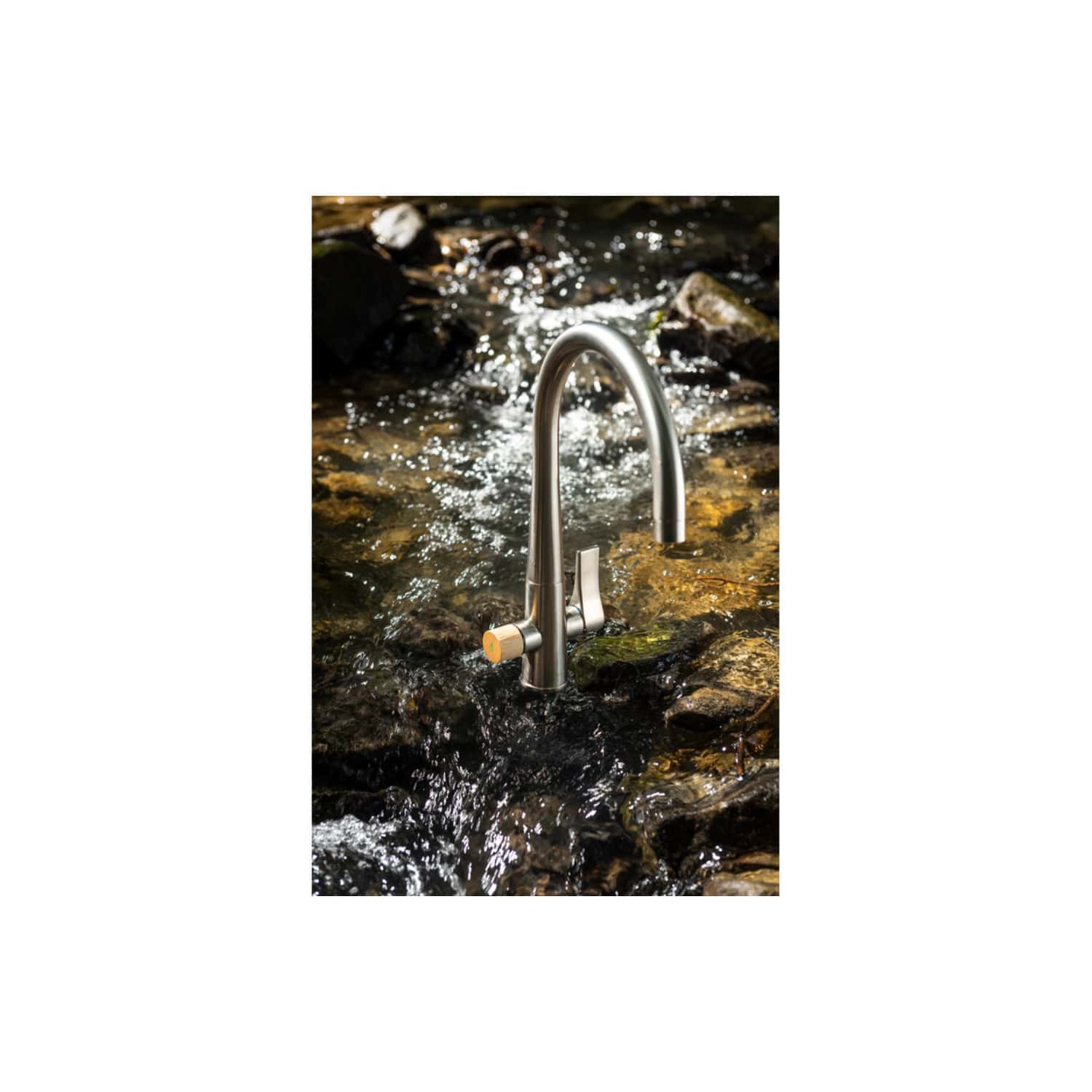 Outdoor stainless steel kitchen faucet installed in a natural stream or river for eco-friendly water access. Perfect for eco-conscious outdoor living and sustainable bathroom design.