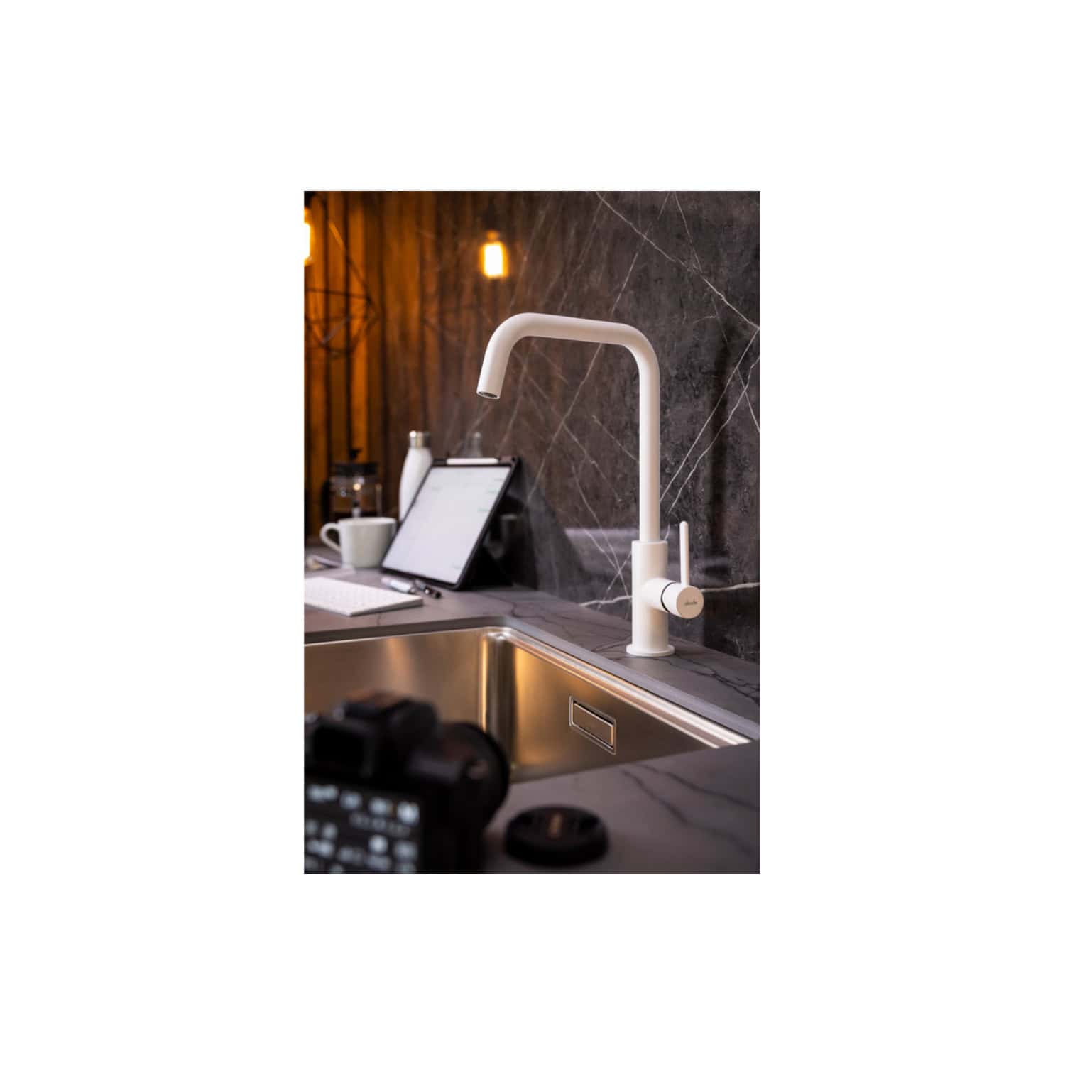 White modern kitchen sink faucet with touchless sensor, sleek design in contemporary kitchen setting, ceramic handle, mounted on marble countertop with stainless steel sink, stylish and functional kitchen fixture.