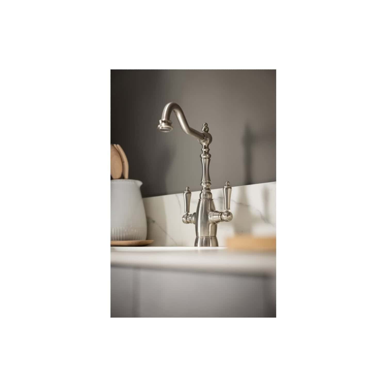 Brushed nickel kitchen sink tap with traditional design, suitable for modern and classic bathrooms and kitchens, providing elegant functionality.
