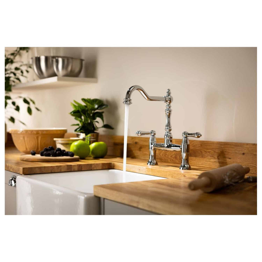 Shiny chrome kitchen faucet with running water, set on a wooden countertop surrounded by fresh apples, berries, and greenery for a stylish and functional modern bathroom or kitchen sink.
