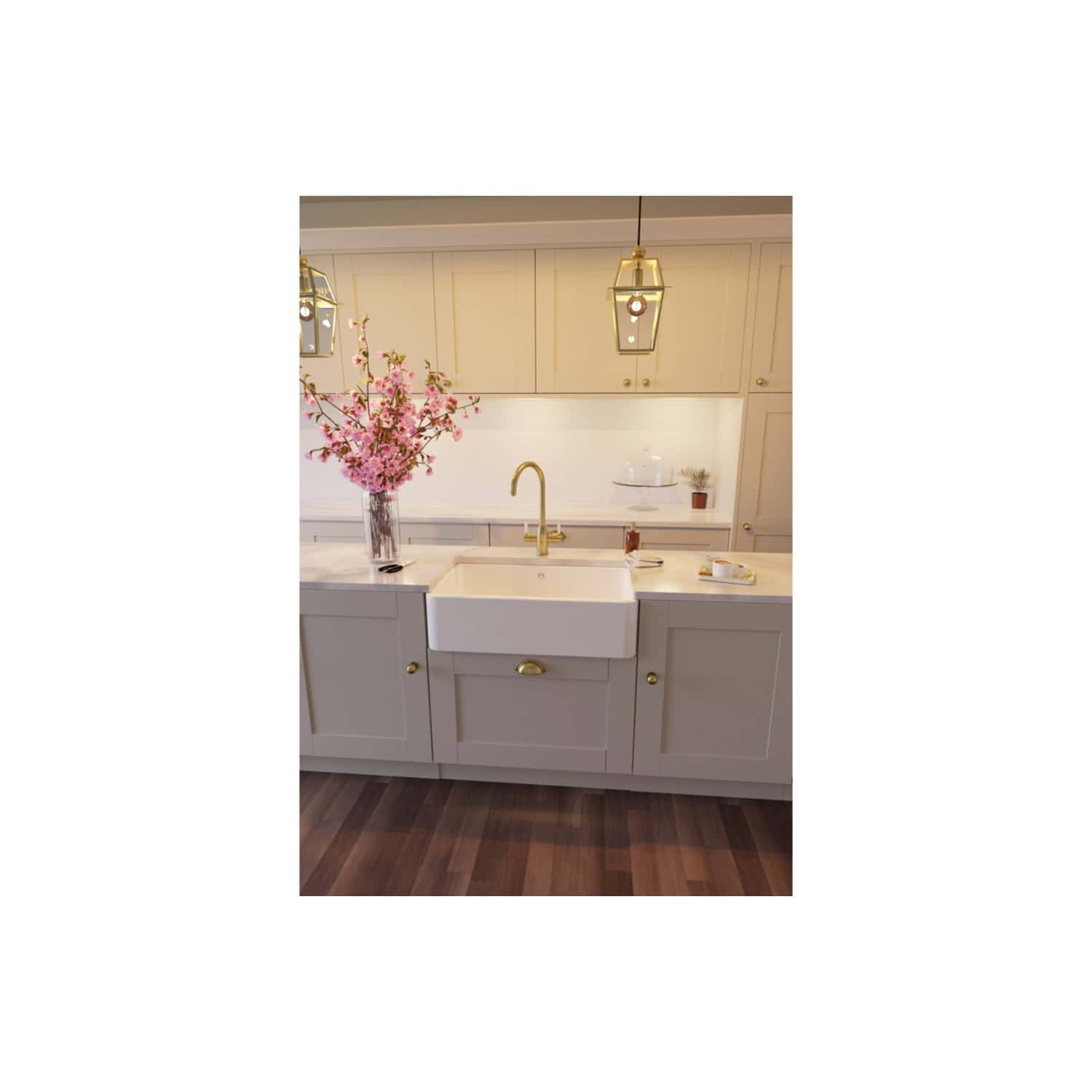 Vessel farmhouse sink with brass fixtures in a modern kitchen featuring white cabinetry and elegant lighting. Perfect for stylish, functional kitchen design and high-end bathroom renovations.