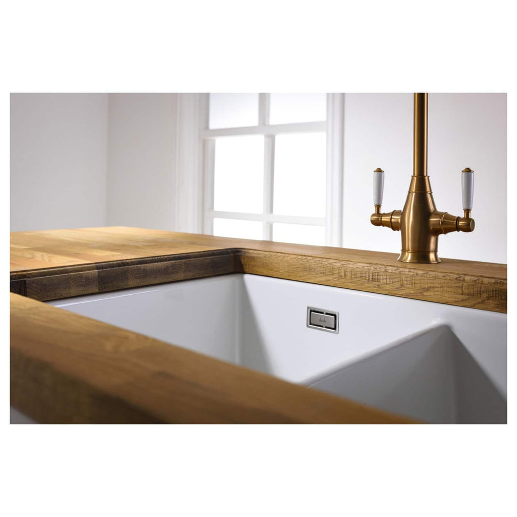 Elegant farmhouse style kitchen sink with a wooden countertop and a gold vintage-style faucet, perfect for modern bathroom or kitchen renovation projects.