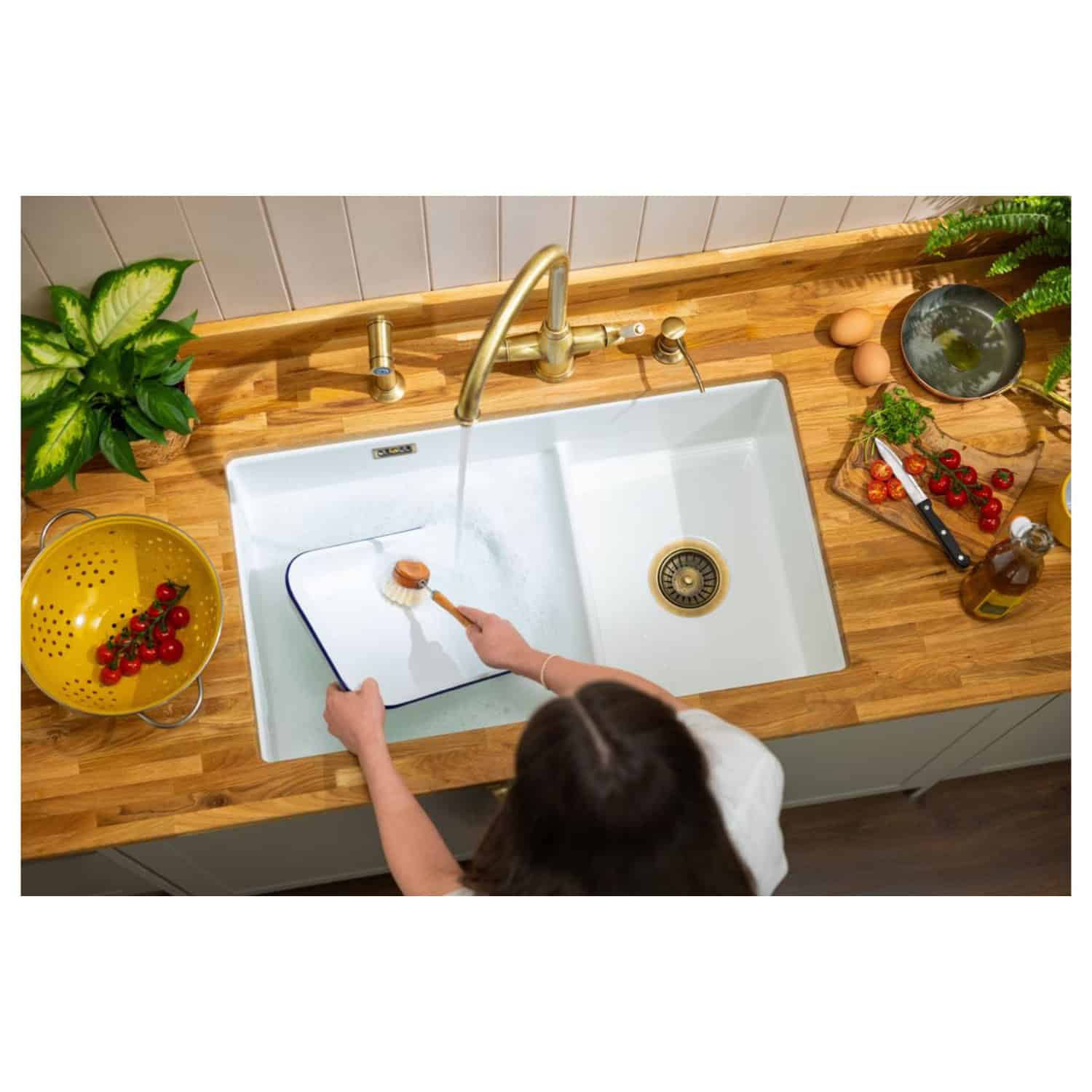 Sustainable kitchen cleaning with eco-friendly scrub brush and natural cleaning products in a modern kitchen. Environmentally conscious cleaning practices.