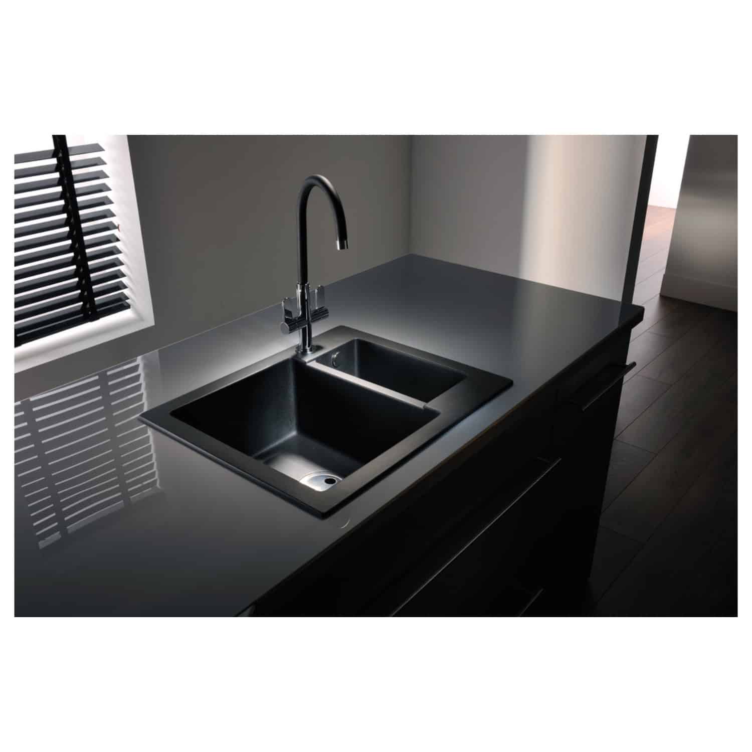 Shiny stainless steel kitchen sink with dual basins and modern black faucet in a contemporary kitchen setting, featuring sleek countertops and minimalist design.