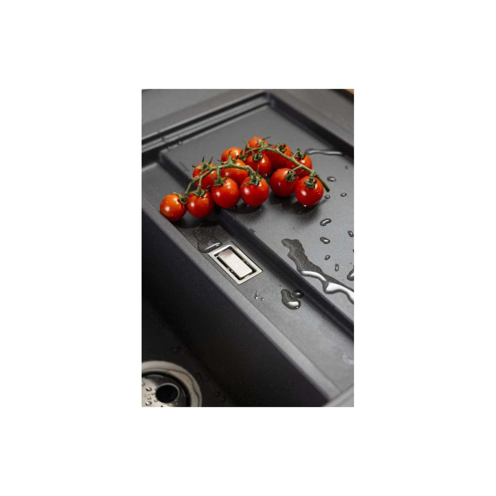 Fresh cherry tomatoes on a modern kitchen sink with water droplets, highlighting kitchen cleanliness and fresh produce. Perfect for emphasising kitchen design or food preparation in bathroom and kitchen environments.