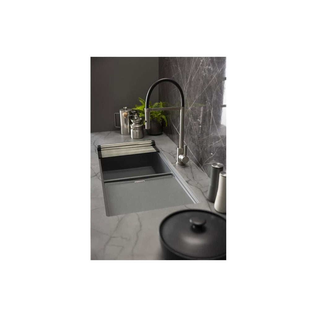 Sleek modern grey kitchen sink with a pull-out drying rack, stainless steel tap, and contemporary accessories on a marble countertop with dark marble wall tiles.