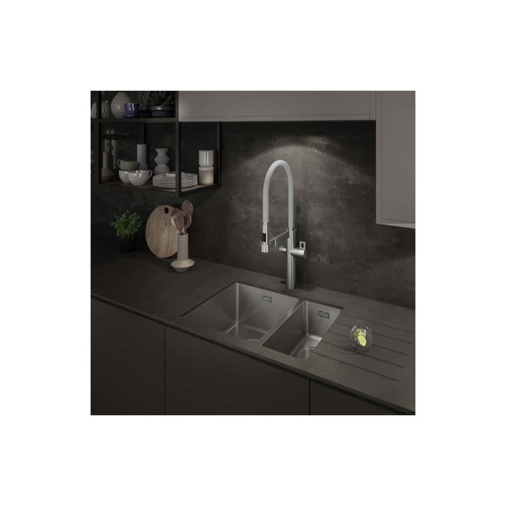 Sleek modern kitchen sink with high-arc mixer tap in a contemporary kitchen setting, featuring minimalist design and dark grey cabinetry for a stylish, functional space.