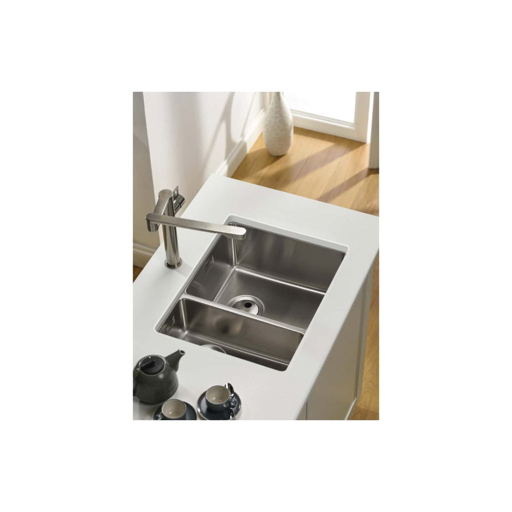 Stainless steel kitchen sink with modern chrome tap in a contemporary kitchen setting, ideal for stylish and functional bathroom or kitchenette renovations.