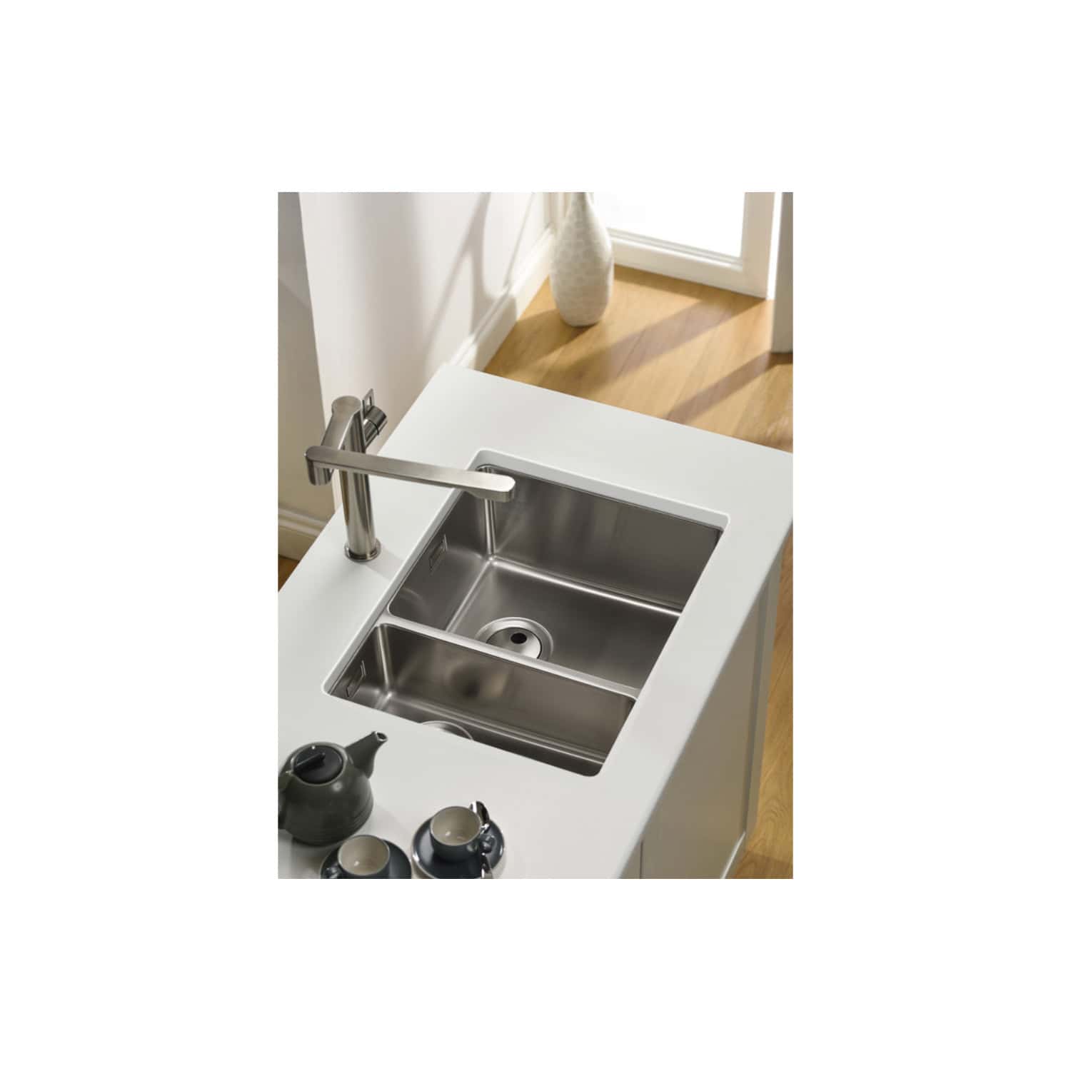Stainless steel kitchen sink with modern chrome tap in a contemporary kitchen setting, ideal for stylish and functional bathroom or kitchenette renovations.