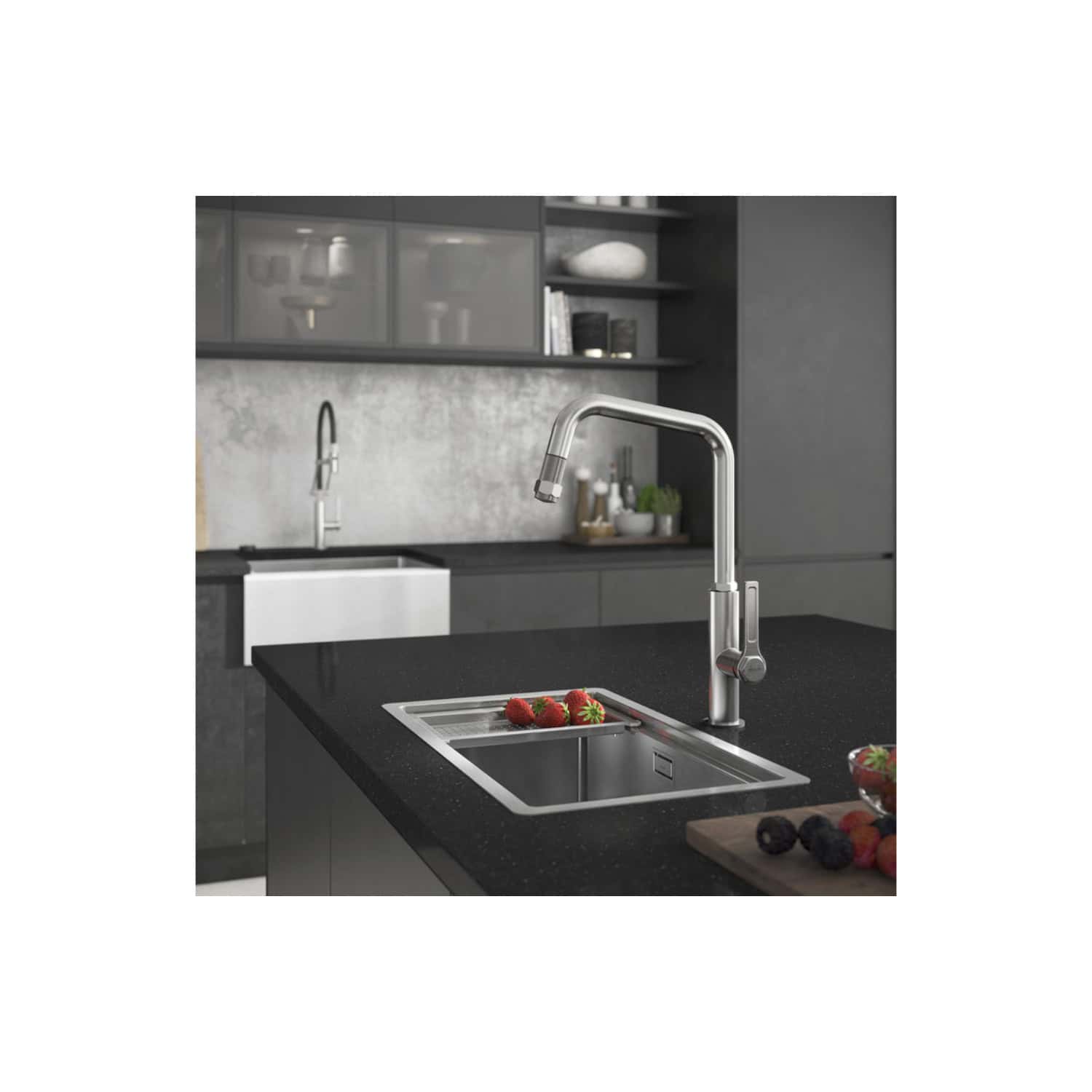 Stainless steel kitchen tap installed above a black granite sink in a modern grey kitchen with open shelving and fresh fruit.