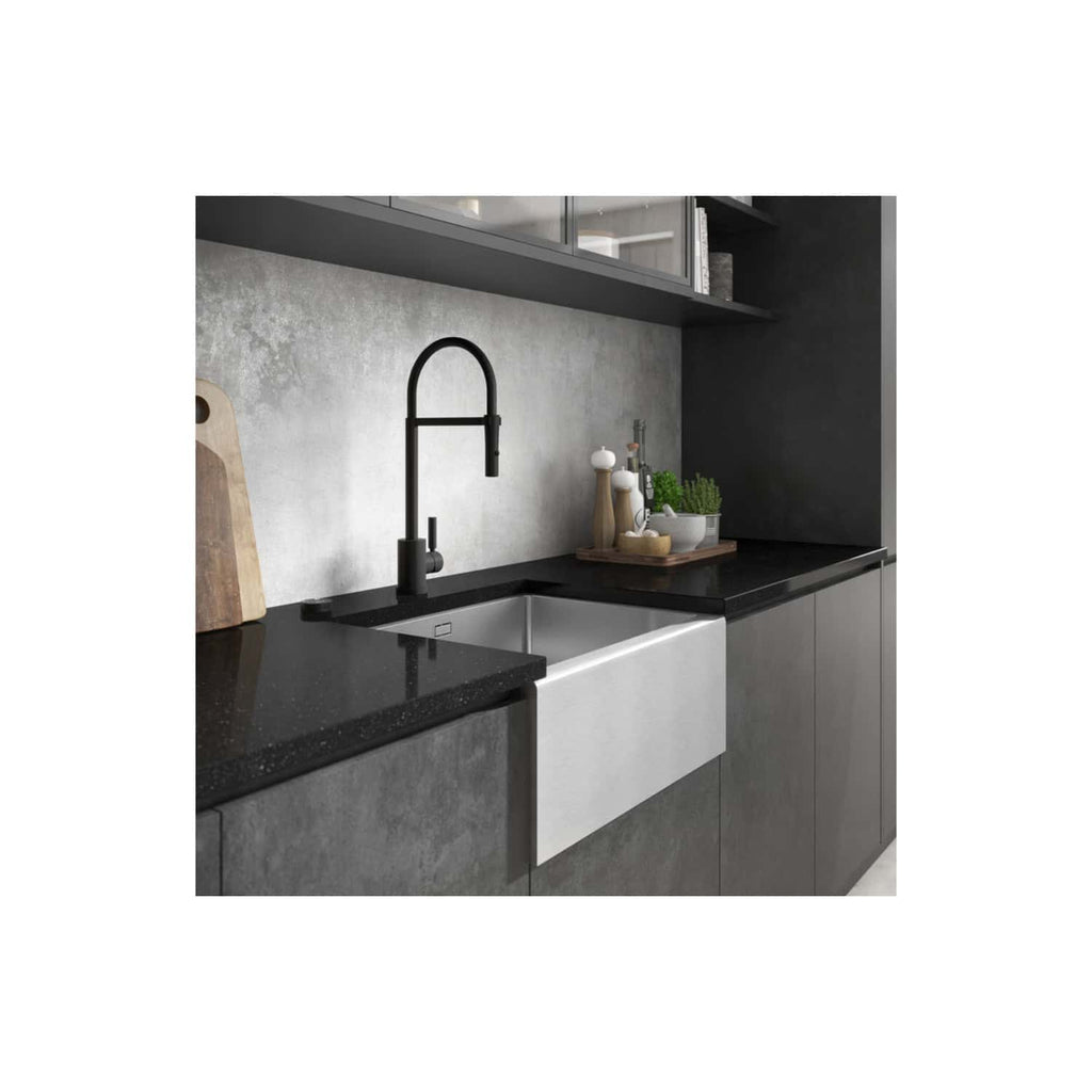 Sleek modern kitchen with black countertop, stainless steel sink, black matte faucet, grey cabinetry, and minimalist decor, showcasing contemporary kitchen design and high-quality materials.
