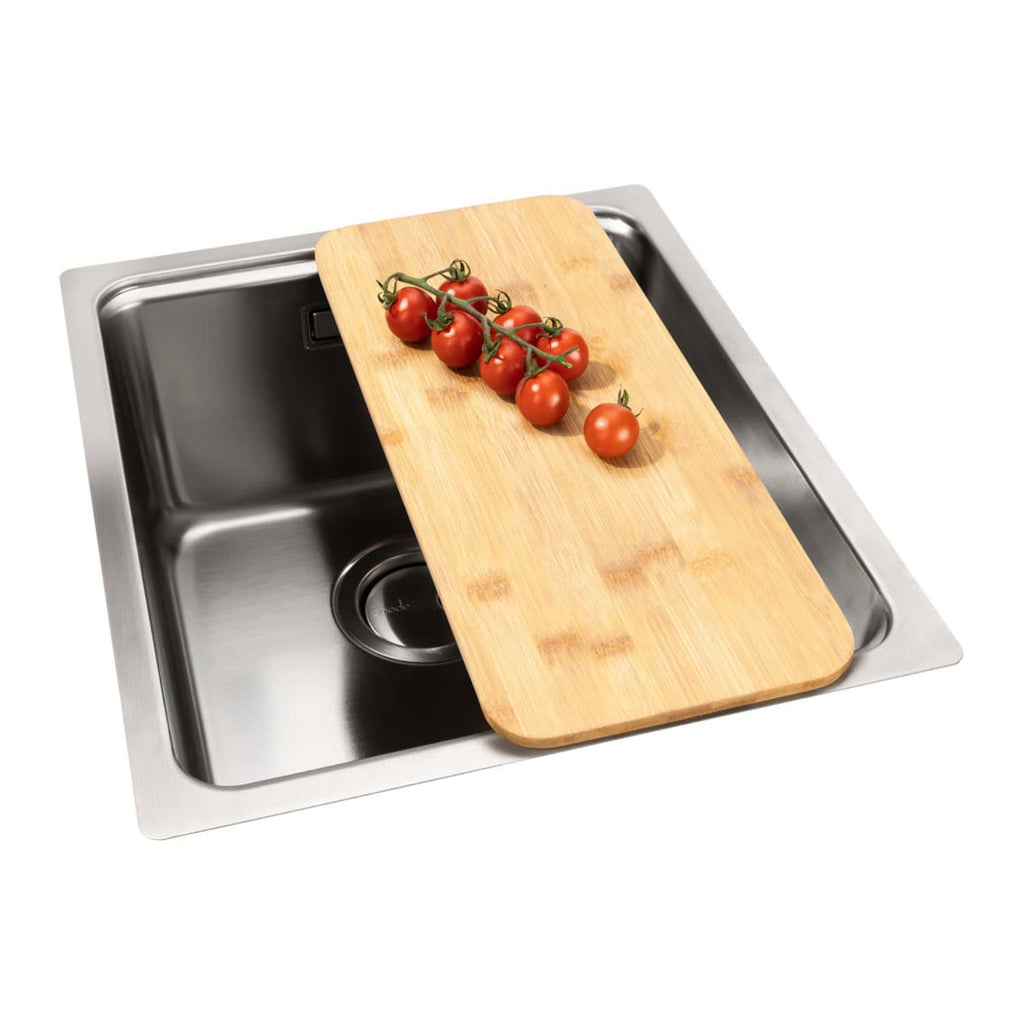 Fresh cherry tomatoes on a vine placed on a wooden chopping board over a stainless steel kitchen sink. Perfect for cooking and food preparation in modern kitchens.