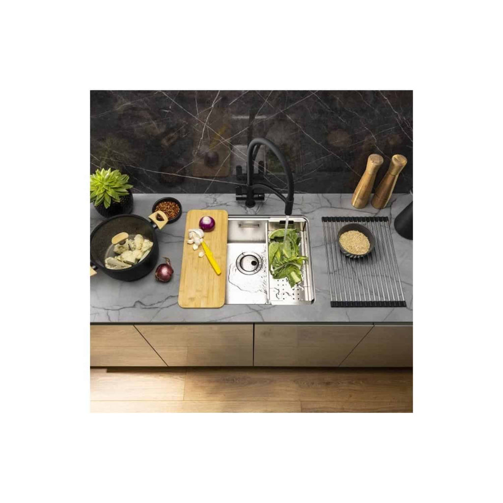 Modern kitchen sink with black faucet and grey marble countertop, surrounded by cooking utensils, fresh ingredients, and seasonal vegetables, highlighting stylish and functional kitchen design.