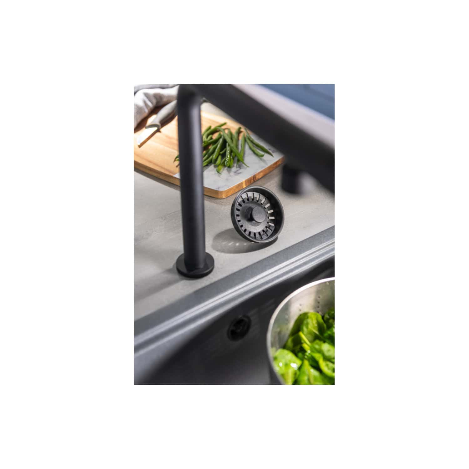 Cooking water-saving tap filter in modern kitchen sink with fresh vegetables and chopping board; eco-friendly kitchen fixtures for efficient water use and sustainable living.