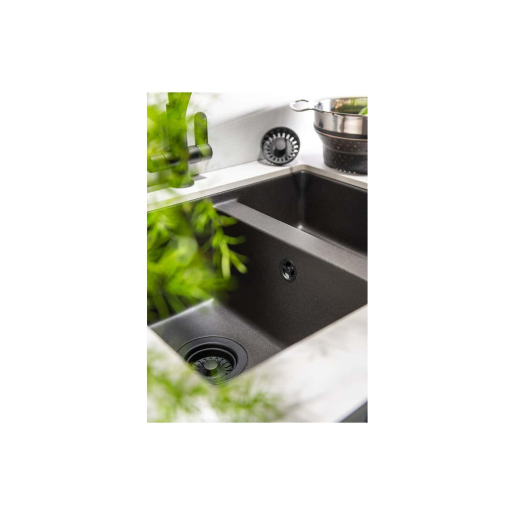 Sleek black kitchen sink with modern design, integrated drain, and surrounding countertop, perfect for contemporary kitchen renovations. Featuring easy-to-clean surfaces and stylish aesthetics.