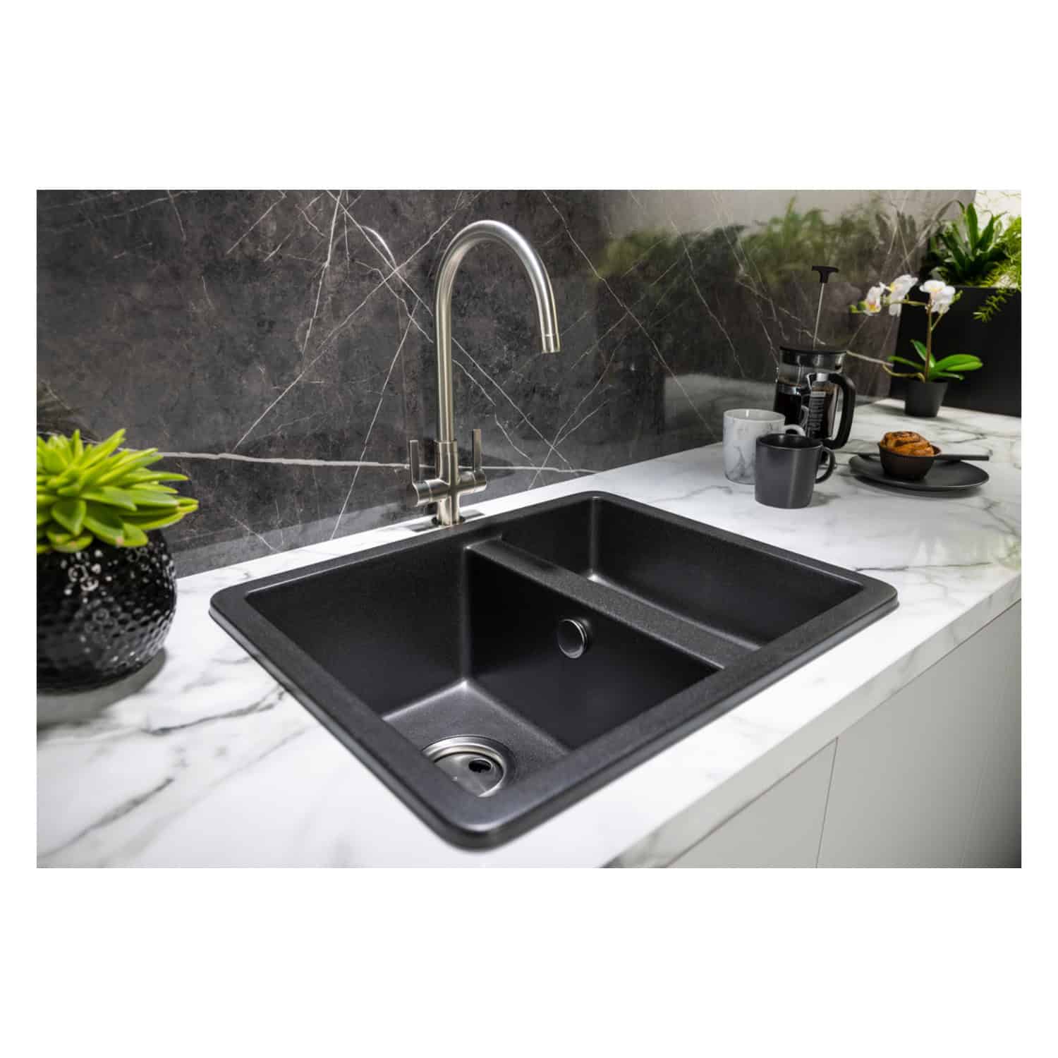 Stainless steel kitchen sink with black finish, installed in a modern white marble countertop, featuring a high-arc chrome faucet and contemporary kitchen accessories. Perfect for stylish and functional kitchen renovations.