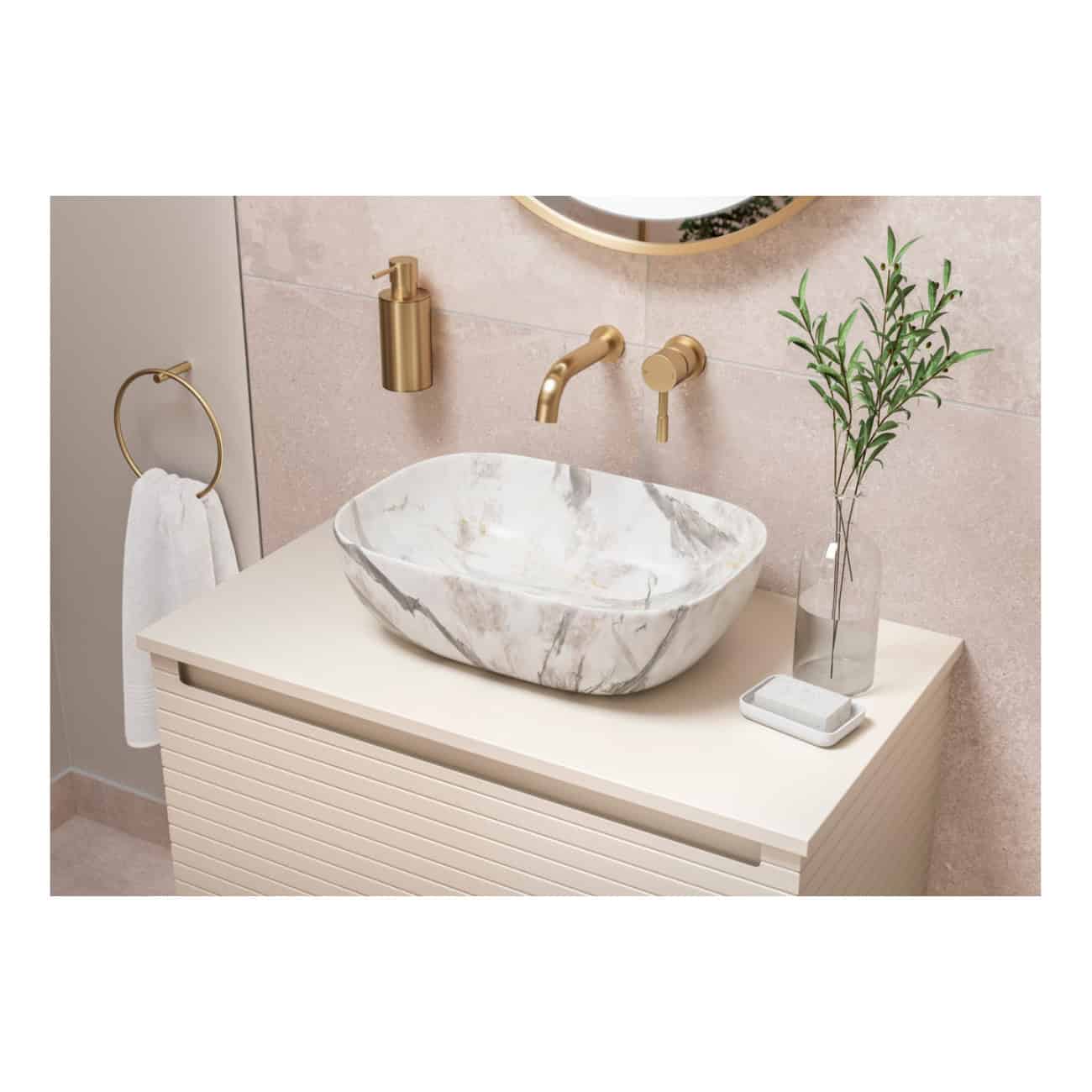 Sleek marble vessel sink with gold fixtures on a modern bathroom vanity, complemented by a minimalist soap dish, glass vase with greenery, and soft neutral tones for elegant bathroom design.