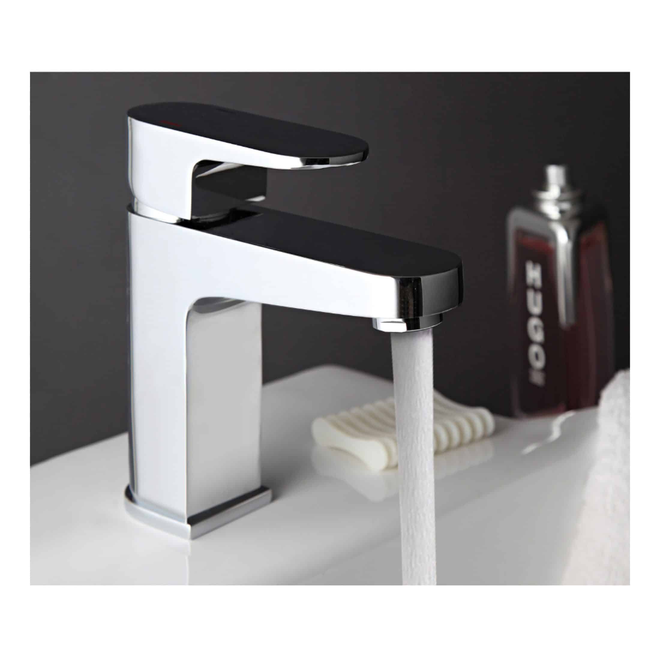 Elegant modern bathroom mixer tap with chrome finish and black handle, water flowing into a white sink, showcasing stylish bathroom fixtures by Bubly Bathrooms.